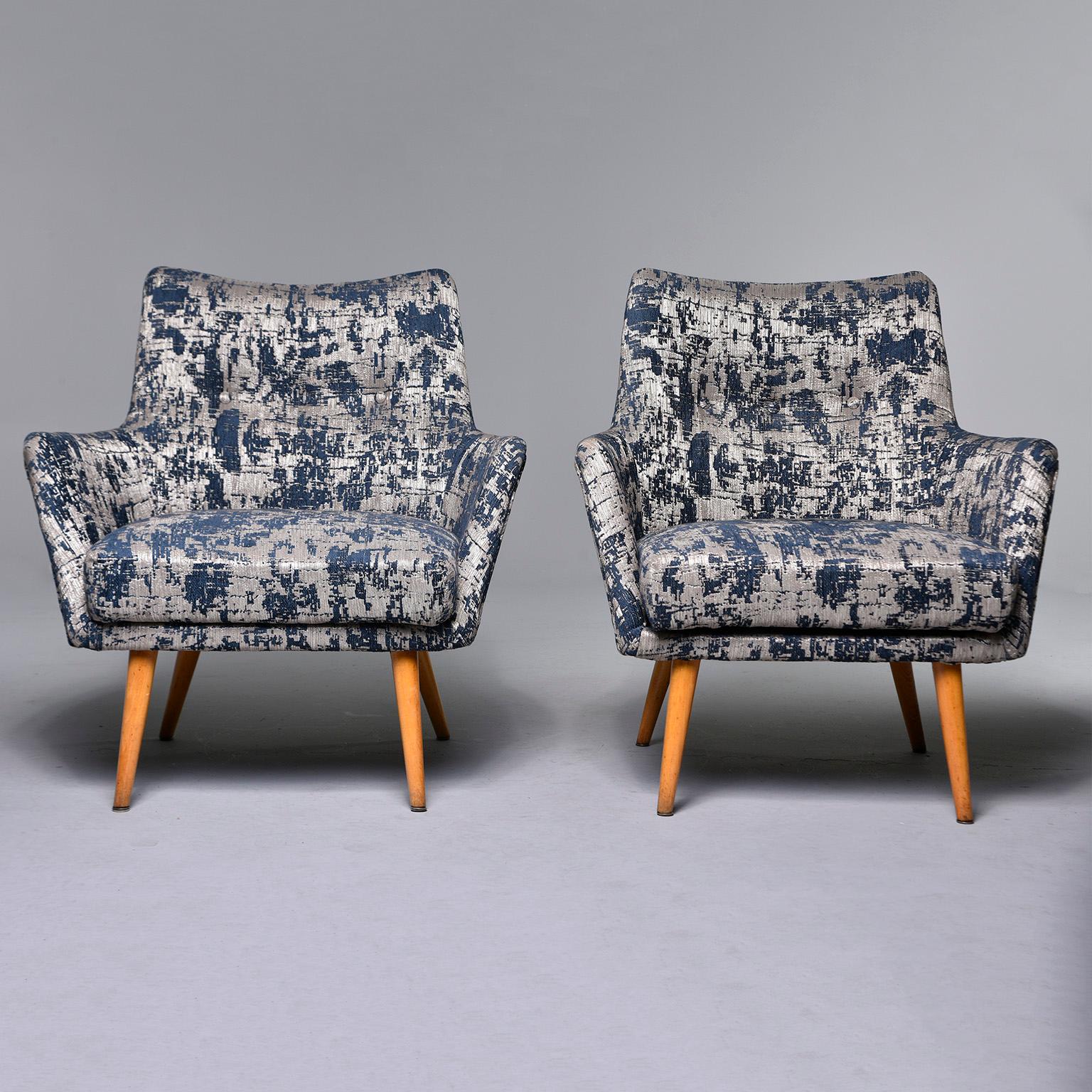Pair of circa early 1960s Italian armchairs feature tapered beech legs and new upholstery with an abstract woven navy blue and silver pattern and button detail on the seatbacks. Unknown maker. Sold and priced as a pair.

Measures: Arm height 22”,