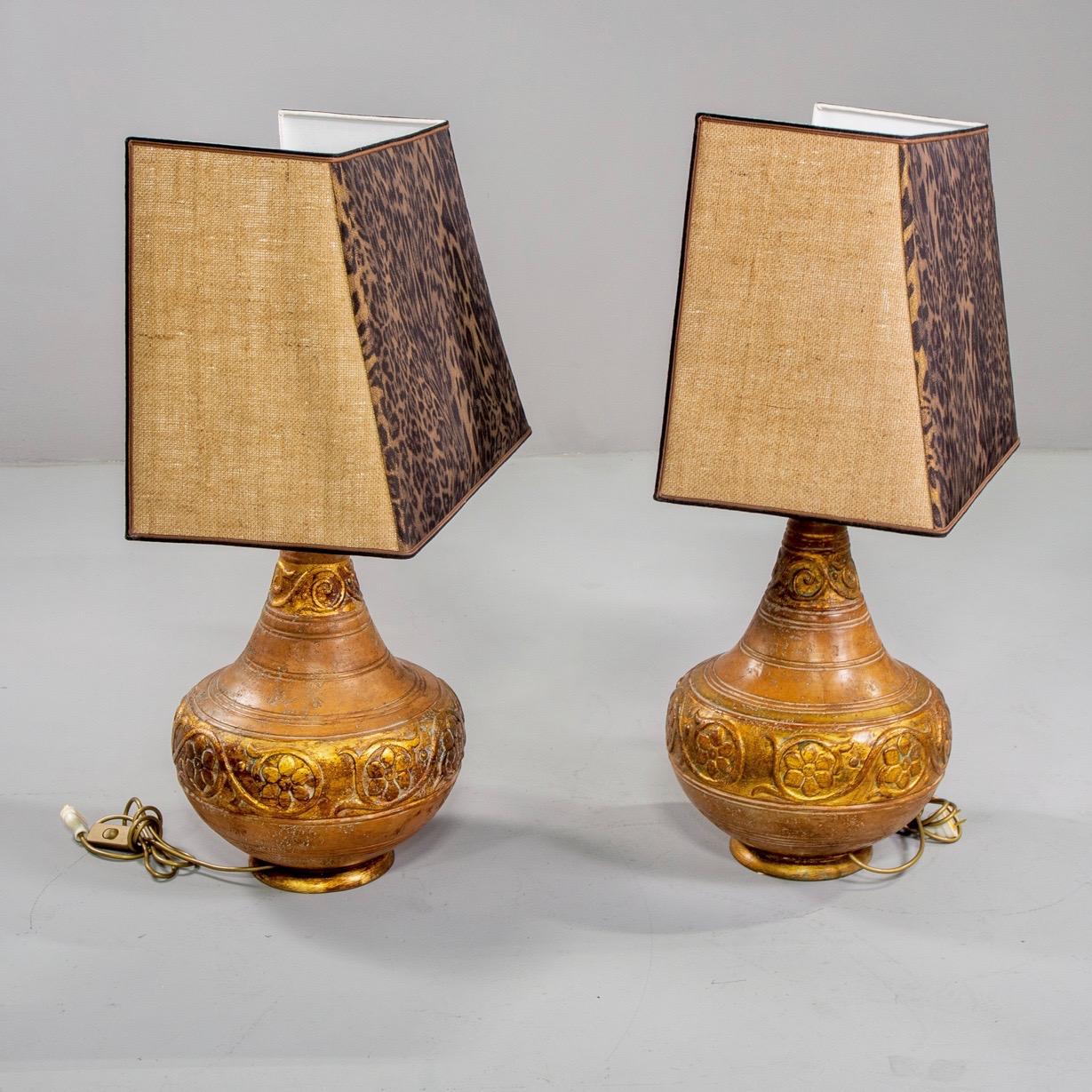 Pair of ceramic Italian lamps feature decorative bands of incised flowers and vines and a warm, Tuscan gold glaze circa 1970s. Custom shades are included and feature a front leopard print panel with natural colored burlap panels on sides. .