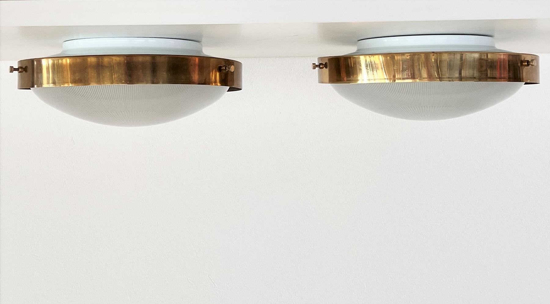 Gorgeous set of two flush mount lights, which can be used also as wall lights.
Made in Italy in the late mid-century 1970s.
Both lights have a central glass dome with beautiful design, same as known from the lights designed by Sergio Mazza.
Around