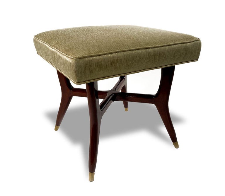 The upholstered seat over 4 tapering legs with brass sabots, and an x form stretcher.
