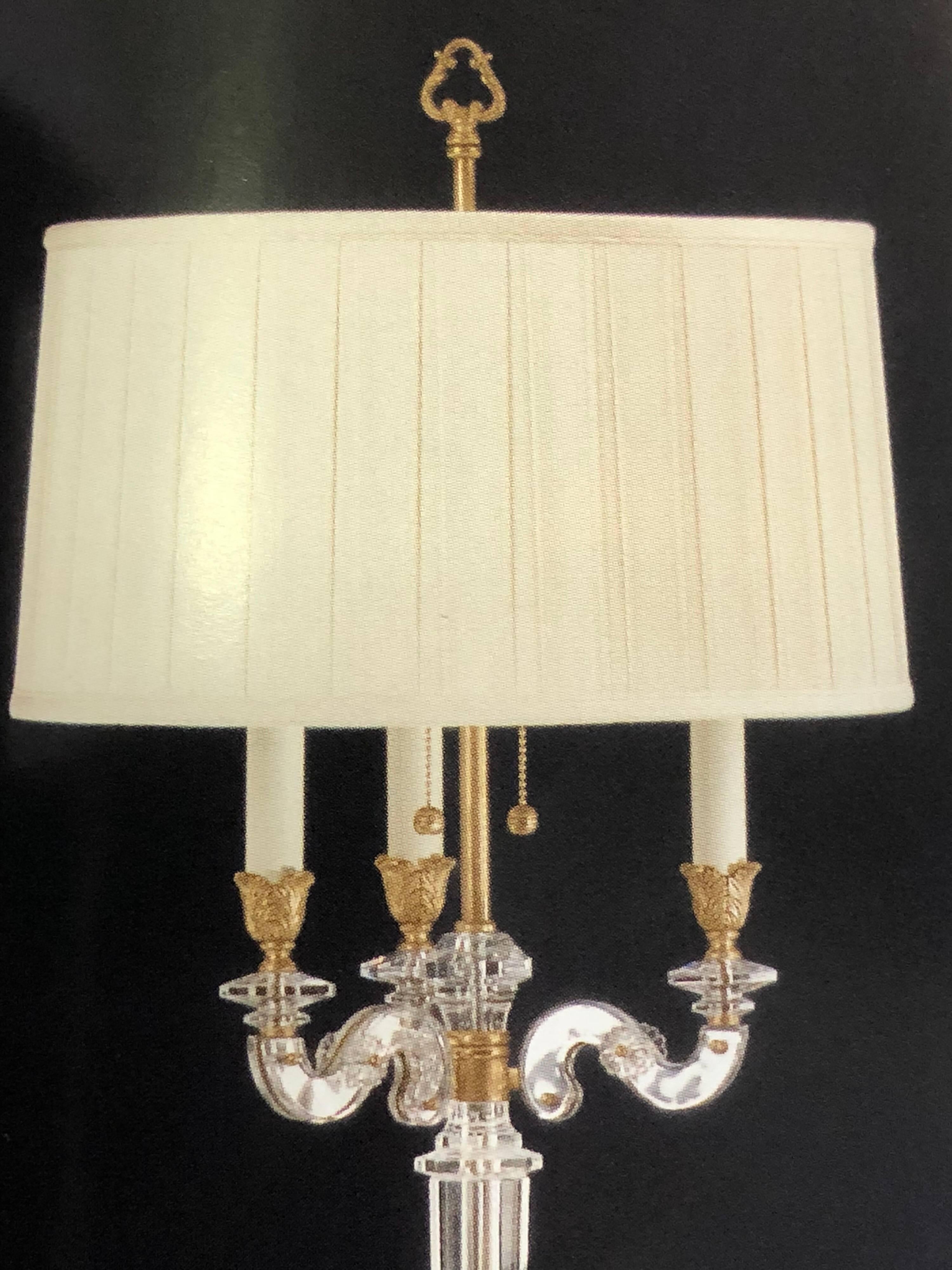 Two Italian Mid-century Style modern neoclassical solid crystal and antiqued solid brass floor lamps in the style of Maison Baguès.

Two Edison sockets at 60 watts per socket; round pleated fabric shades are included. 

References: Venetian glass,