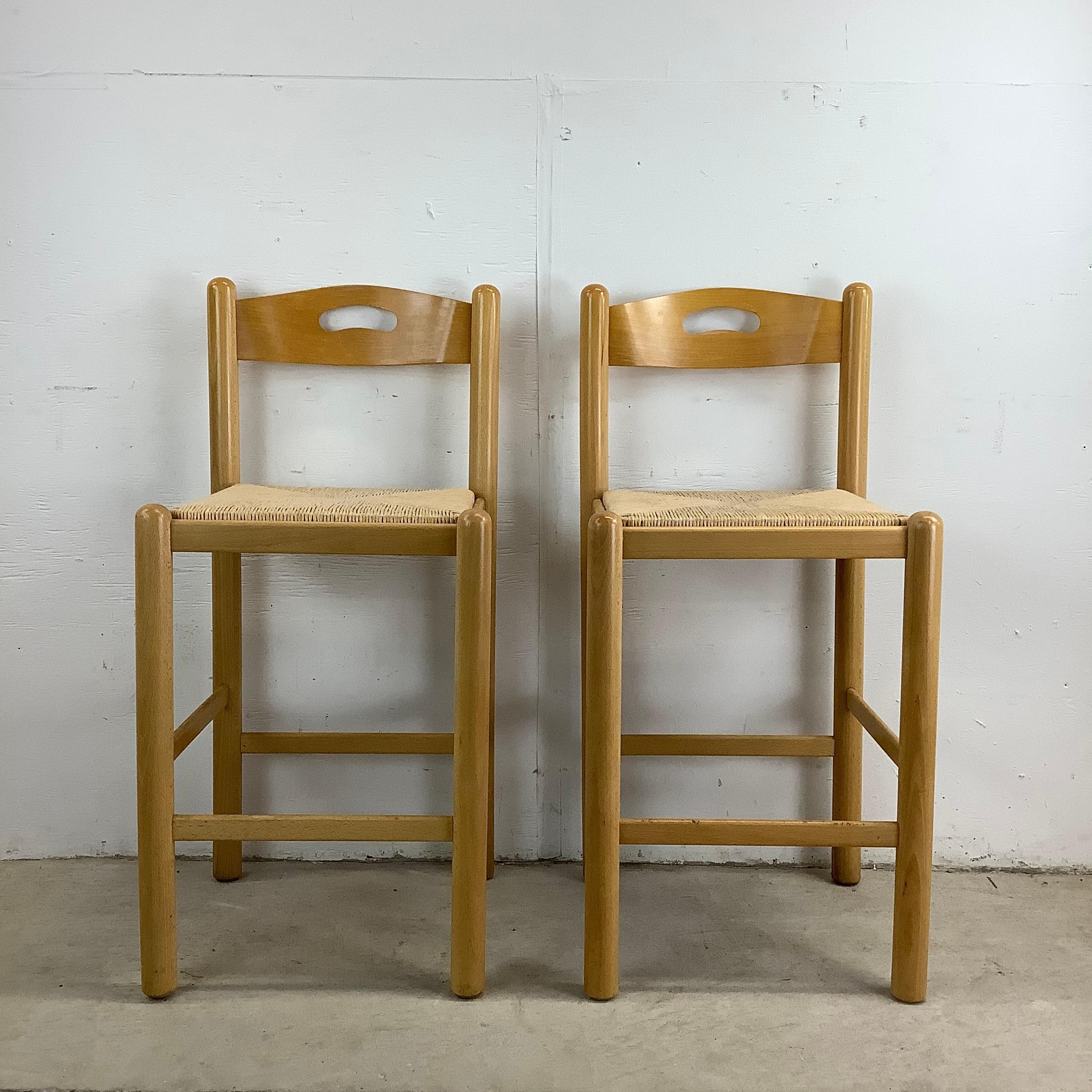 Infuse your kitchen or bar area with rustic elegance with this pair of oak counter stools featuring rush weave seats. Made in Italy, these stools blend natural materials with timeless craftsmanship to create a look that is both sophisticated and
