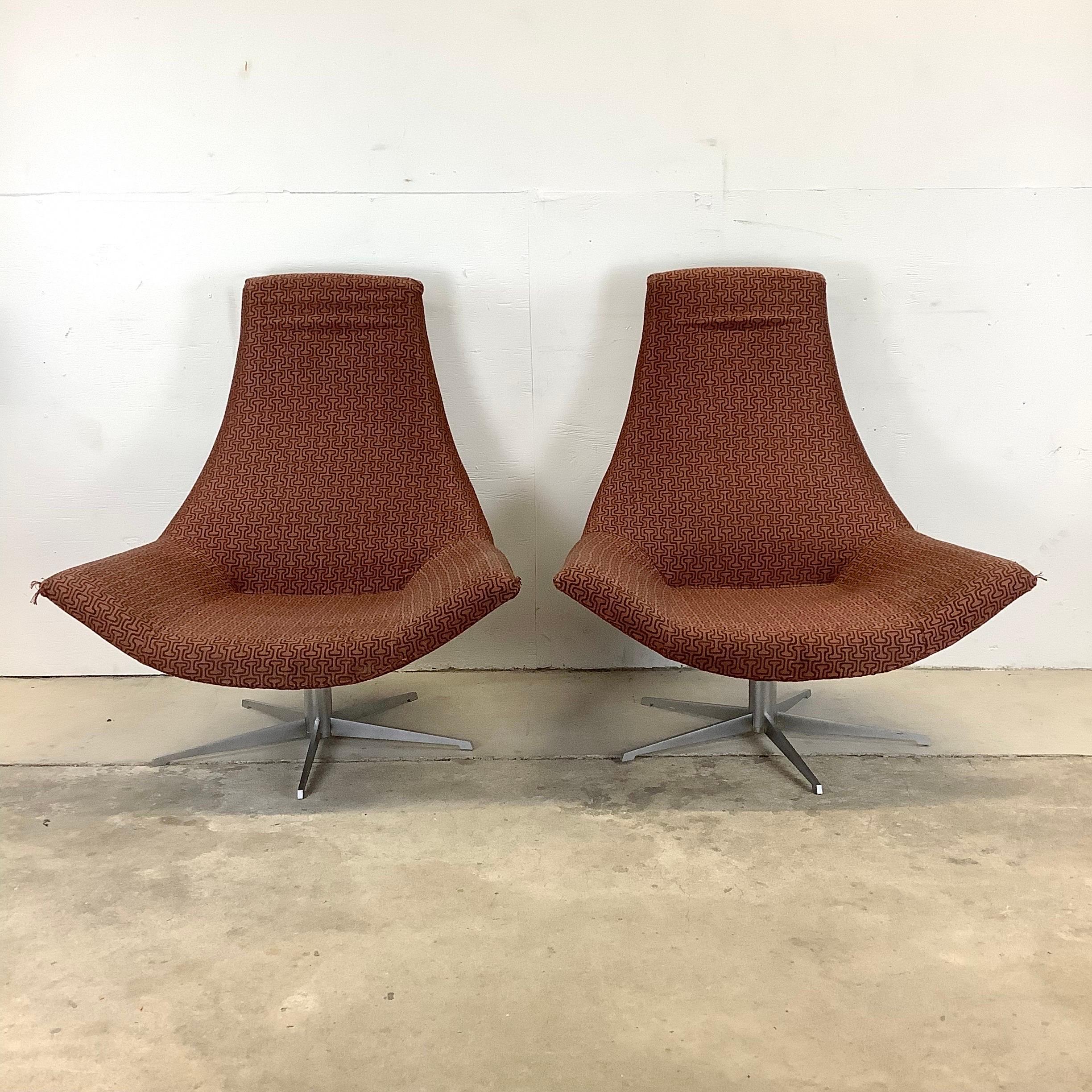 This impressive pair of matching modern lounge chairs feature distinctly Italian sculptural design while offering wide seats and swivel metal bases. The geometric patterned upholstery on this contemporary pair makes an elegant mcm style addition to