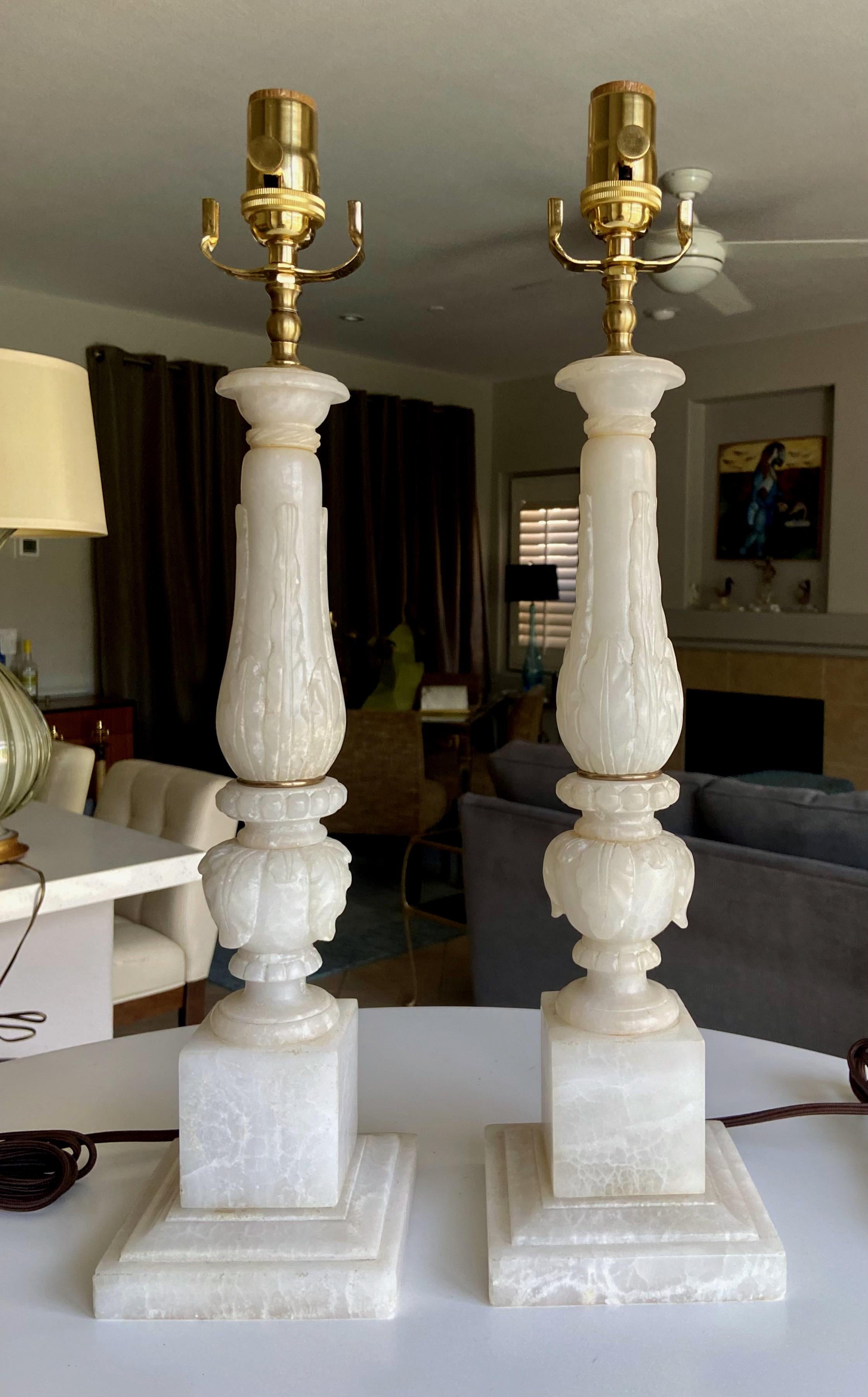 Pair of finely crafted hand carved neoclassic style acanthus leaf theme alabaster lamps. Newly wired with 3 way sockets and rayon covered cords.

.
