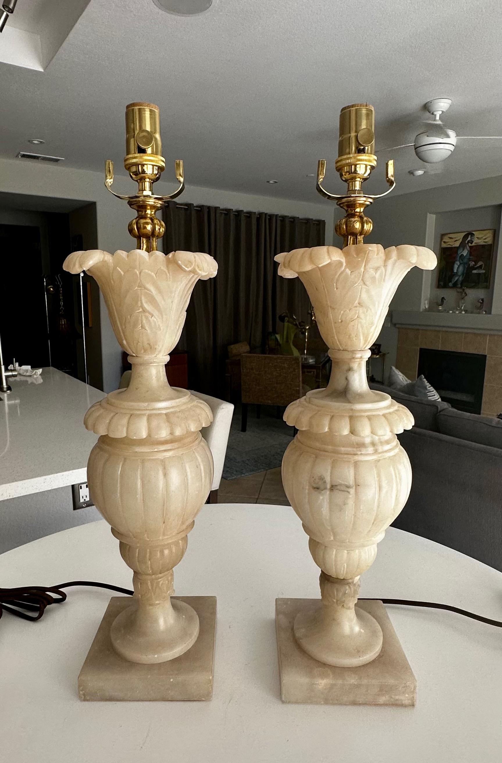 Pair of finely crafted hand carved neoclassic style urn and acanthus leaf theme alabaster lamps. Newly wired with 3 way sockets and rayon covered cords.

.