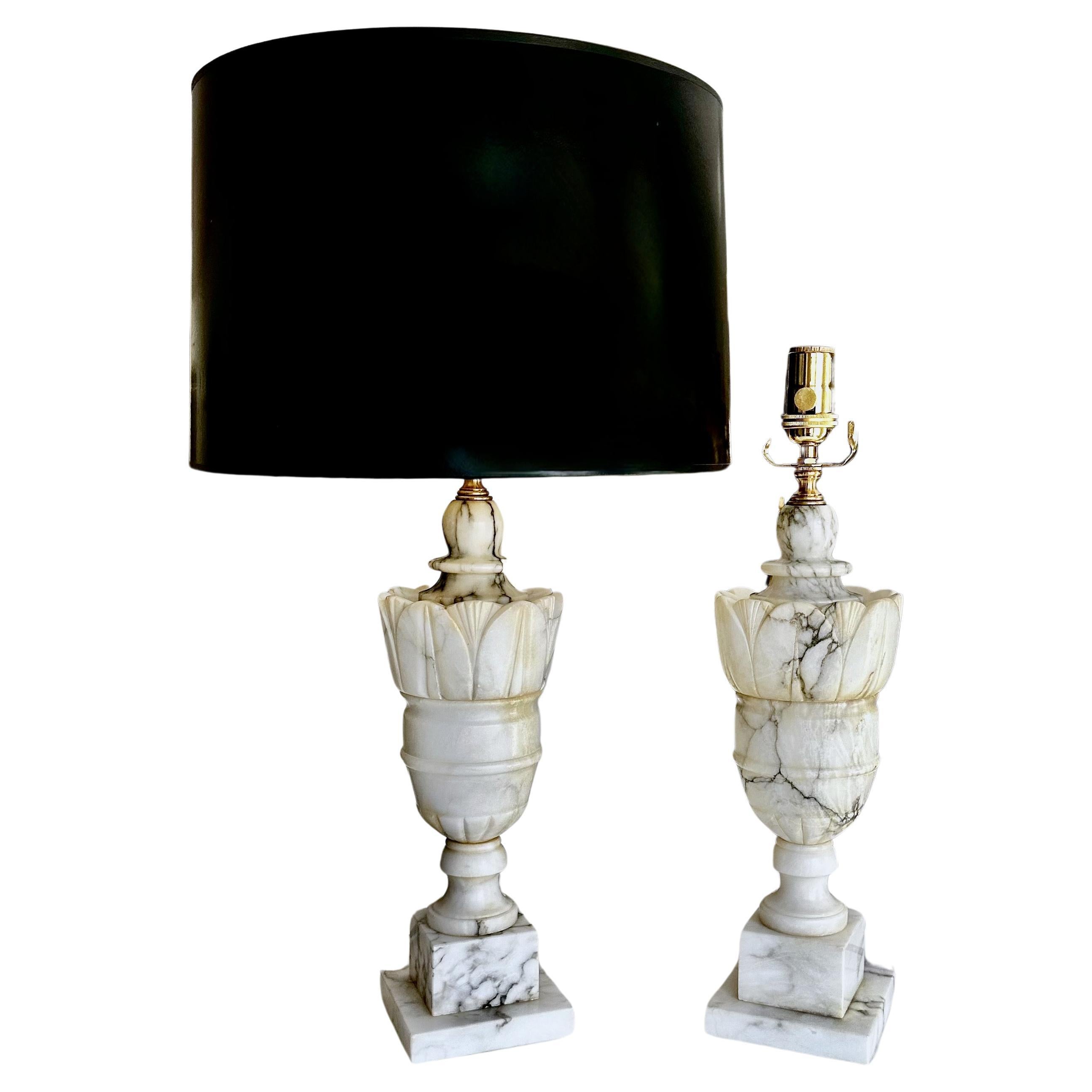 Pair of finely crafted hand carved neo-classic style urn form alabaster lamps. The intricately carved white alabaster are covered with lots natural colorful veining. Newly wired with 3 way sockets and rayon covered cords. Overall height top of