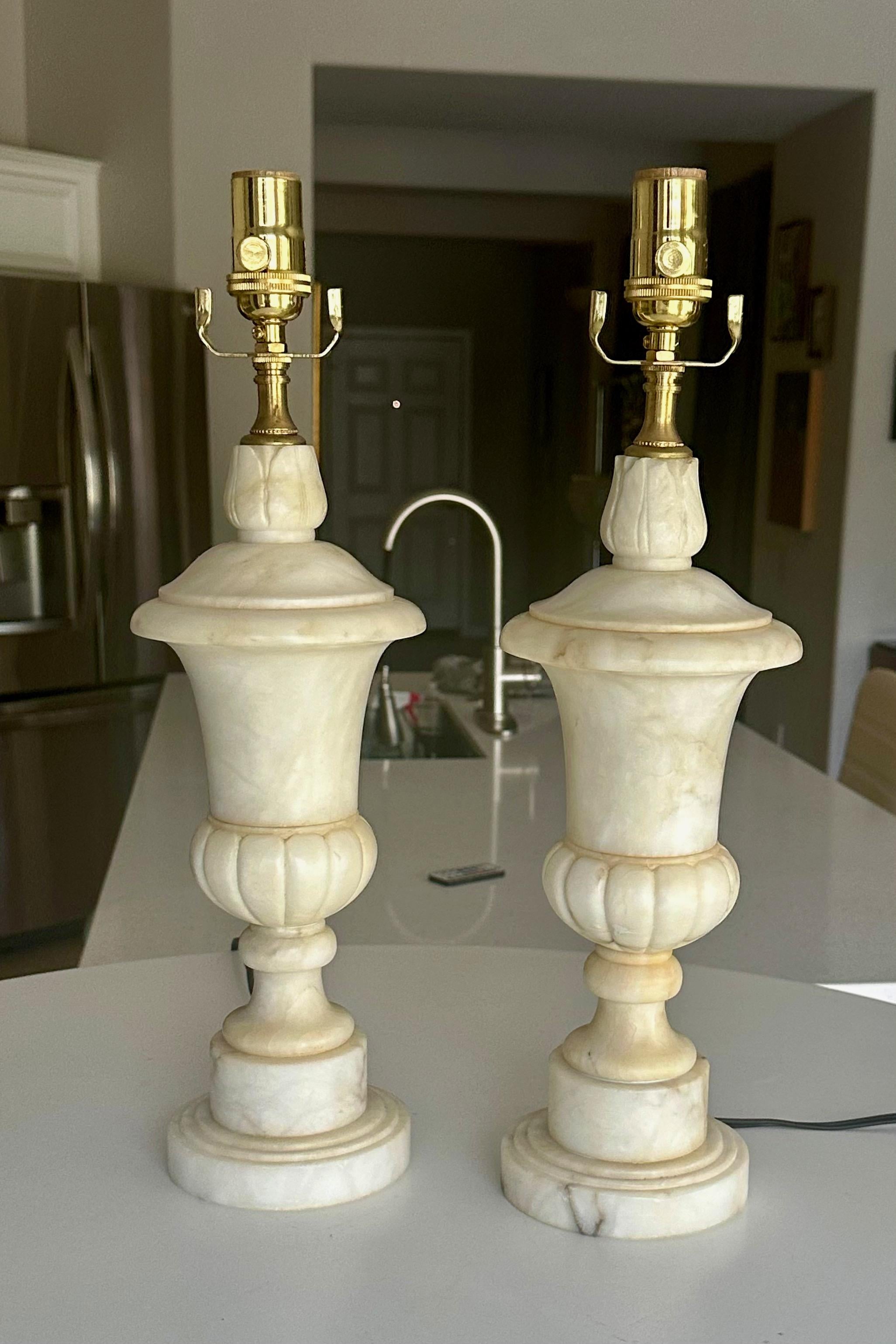Pair of finely crafted hand carved neo-classic style urn form alabaster lamps. Newly wired with 3 way sockets and  cords. Overall height top of socket 19