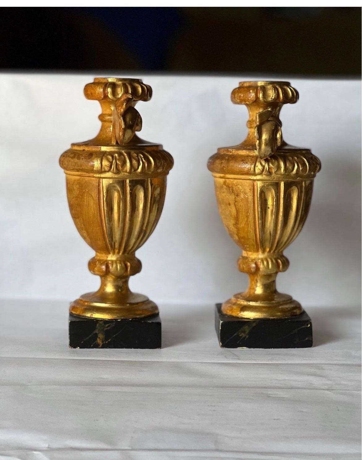 Pair Italian Neoclassical Carved Gilt Wood Ornamental Urns on Faux Marble Bases In Good Condition For Sale In Atlanta, GA