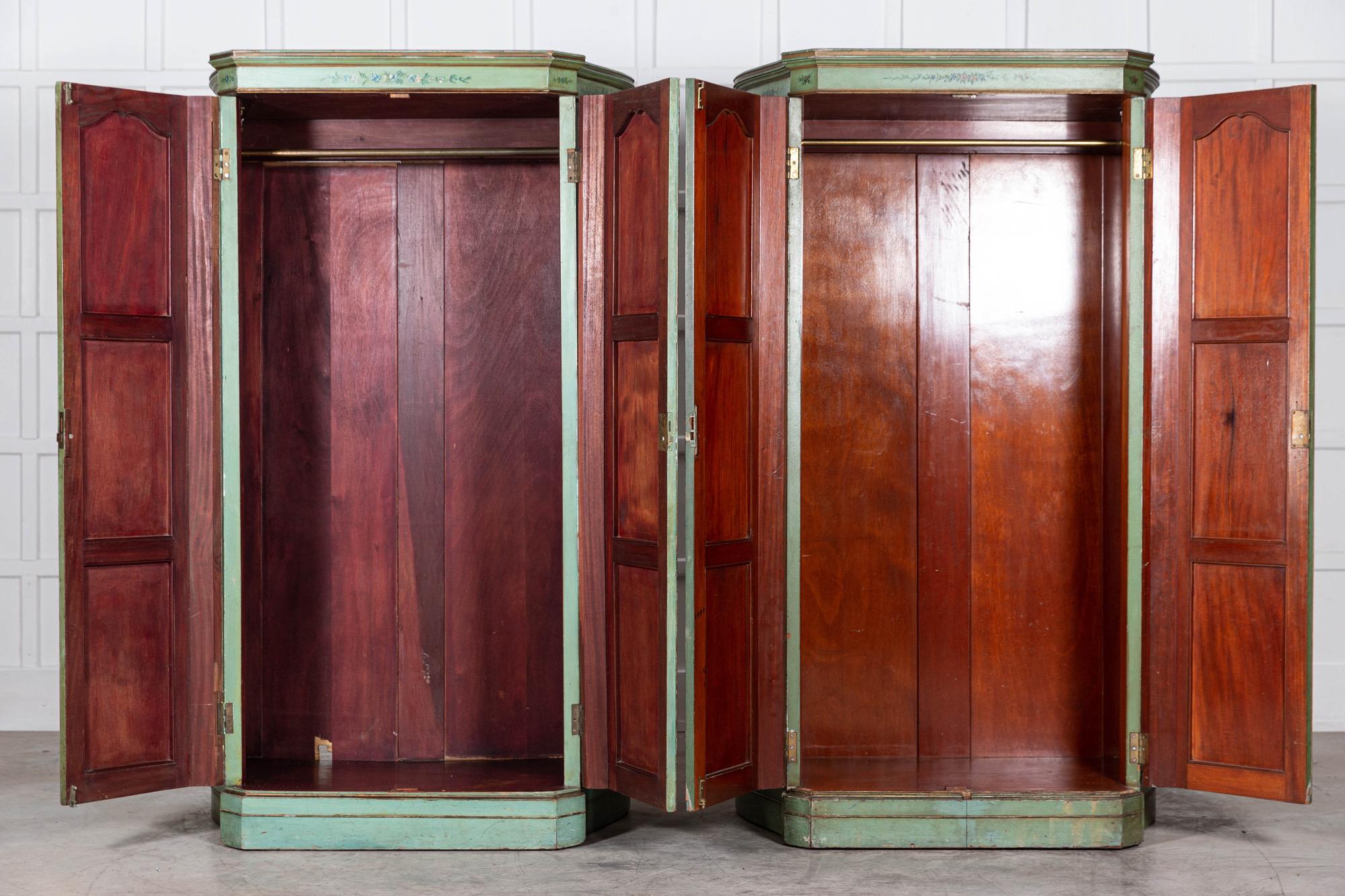 A matched pair of large Italianate green-painted two-door painted Armadio (clothes cupboards) with canted serpentine sides decorated throughout with baskets of fruit and flowers, supported by shaped box plinths. (slight twist in one door).