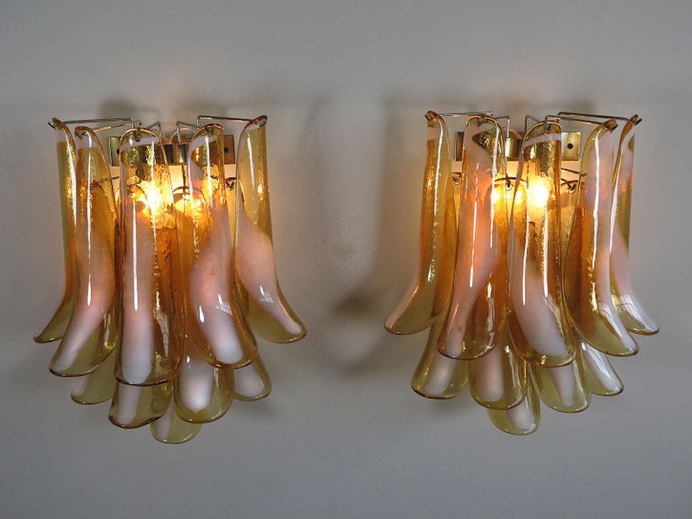 Pair of Vintage Italian Murano appliques in the manner of Mazzega. Wall lights have 10 caramel lattimo glass petals (for each applique) in a chrome frame.
Period: 1970s
Dimensions: 16.50 inches (42 cm) height; 13.80 inches (35 cm) width; 7.90