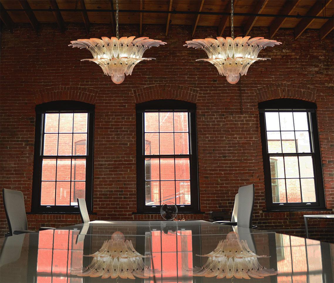 Luxury and genuine pair murano glass chandeliers. Handmade in murano. It made by 58 murano pink glasses in a gold metal frame. The chandelier has also a murano glass ball in the end of the lamp. Murano blown glass in a traditional way.
Period:
