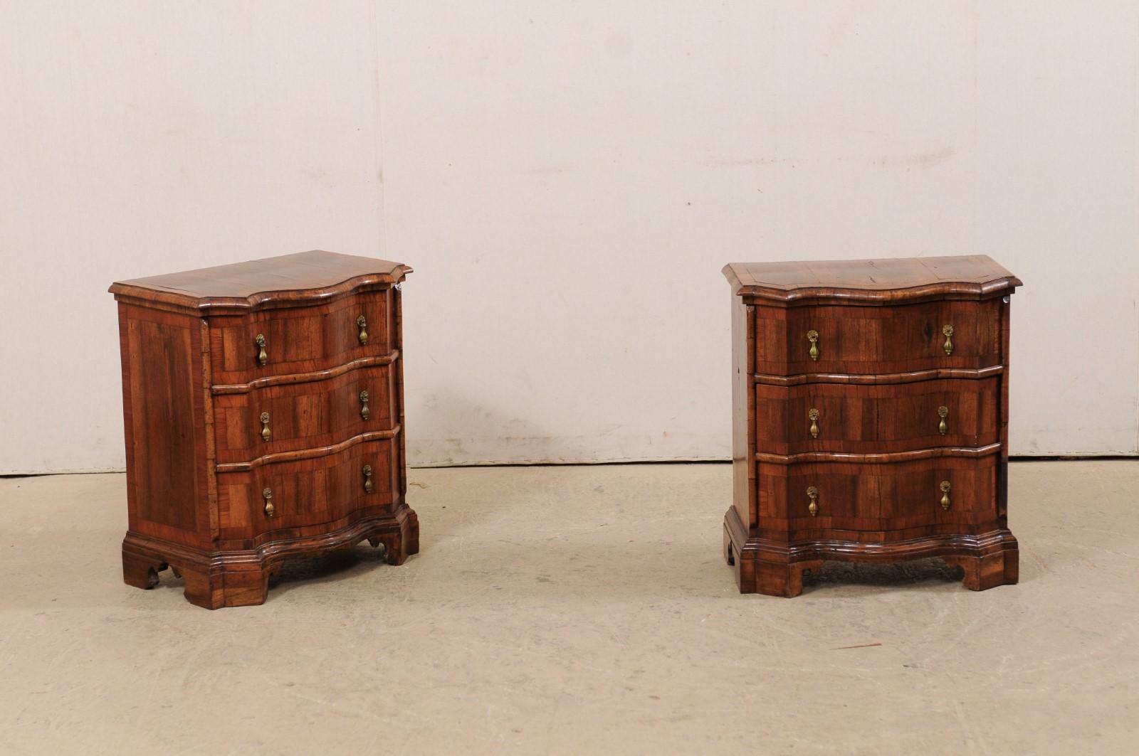 An Italian pair of small serpentine side chests with decorative banding from the turn of the 18th and 19th century. These exquisite petite-sized Italian chests each feature curvy serpentine bodies adorn in a lovely banding about the tops, sides, and