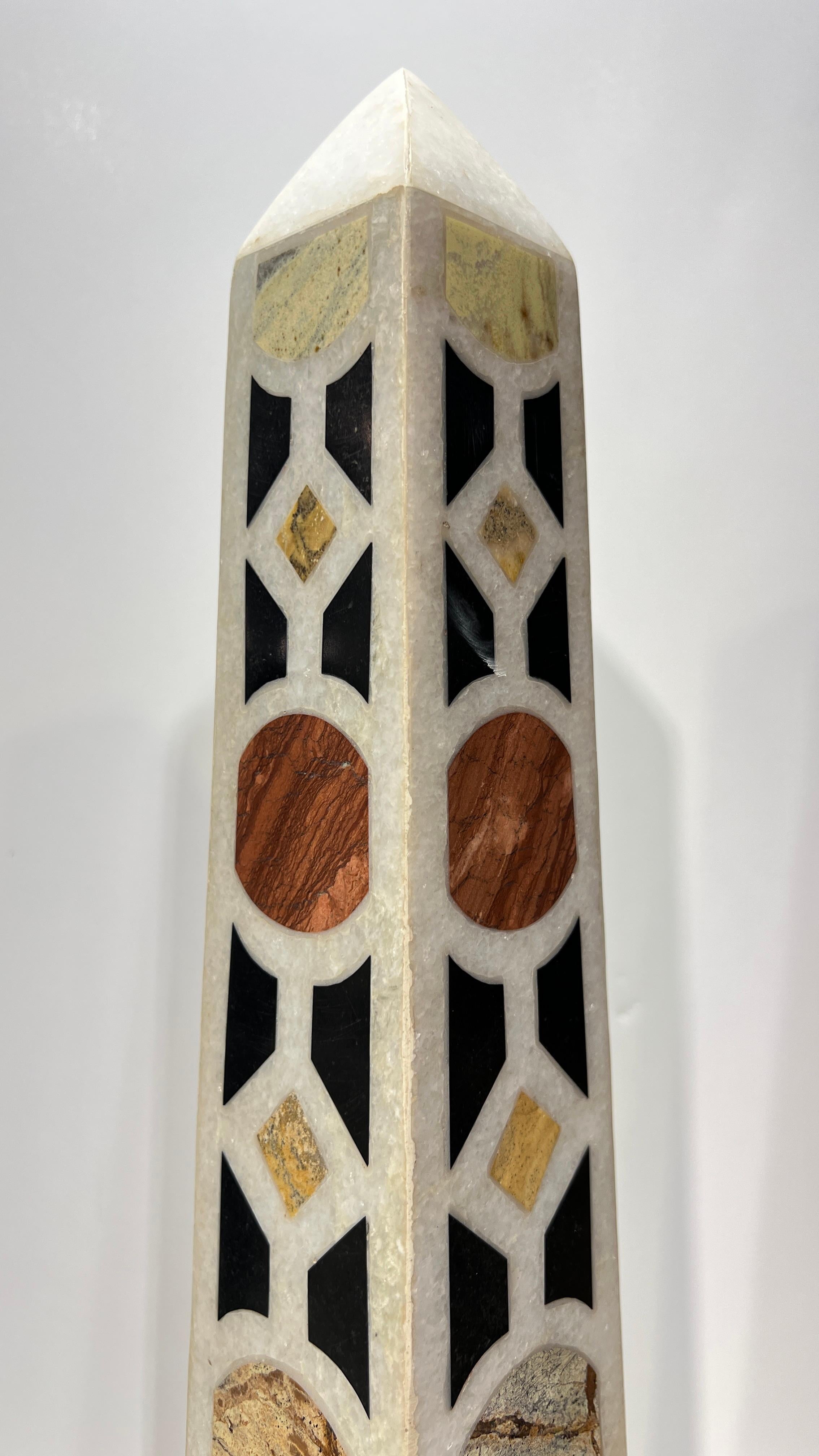 Pair of Italian specimen marble obelisks measuring 23 inches tall and 5 inches wide and deep.