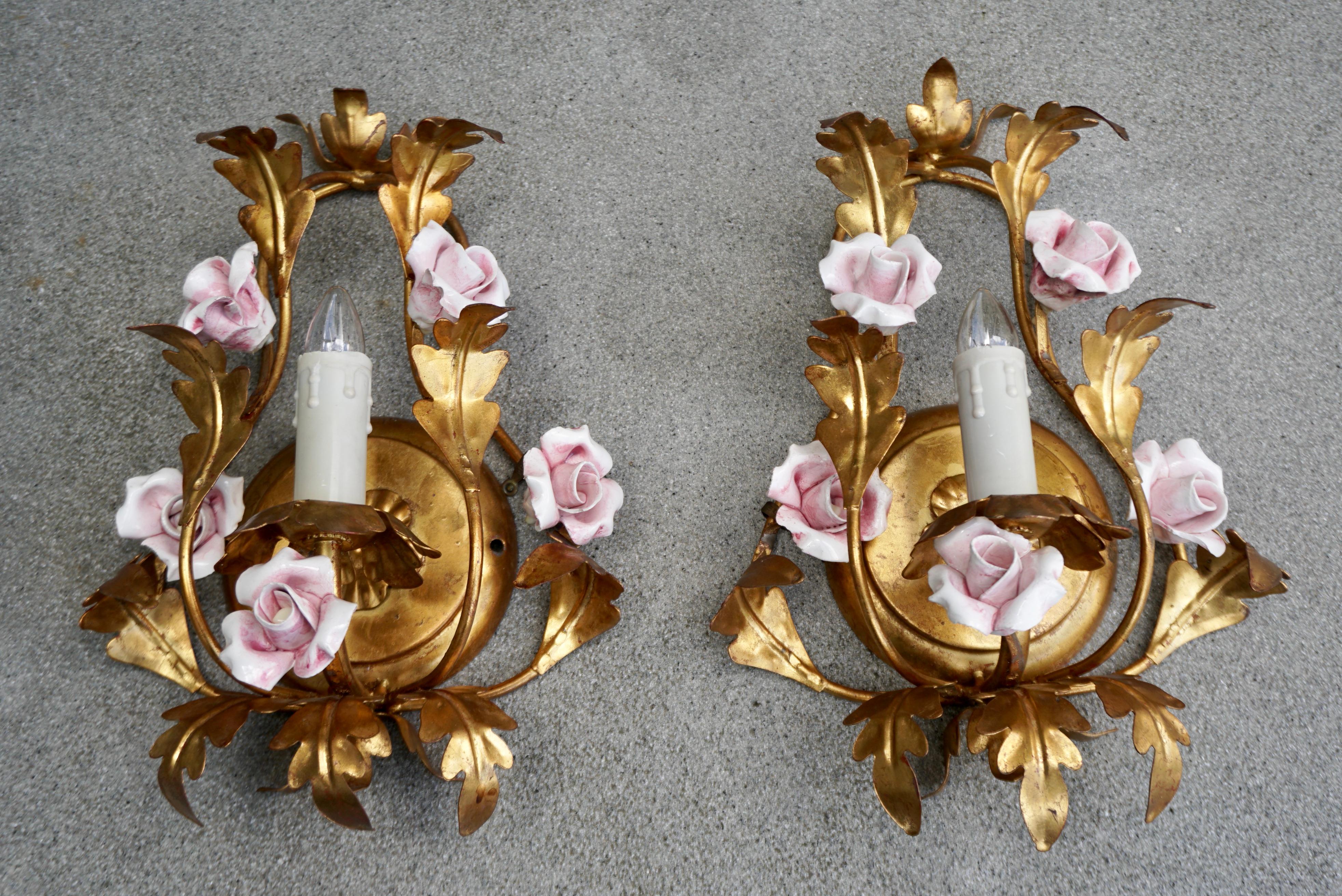 Pair Italian Hollywood Regency wall lights in brass with pink porcelain rose flowers.