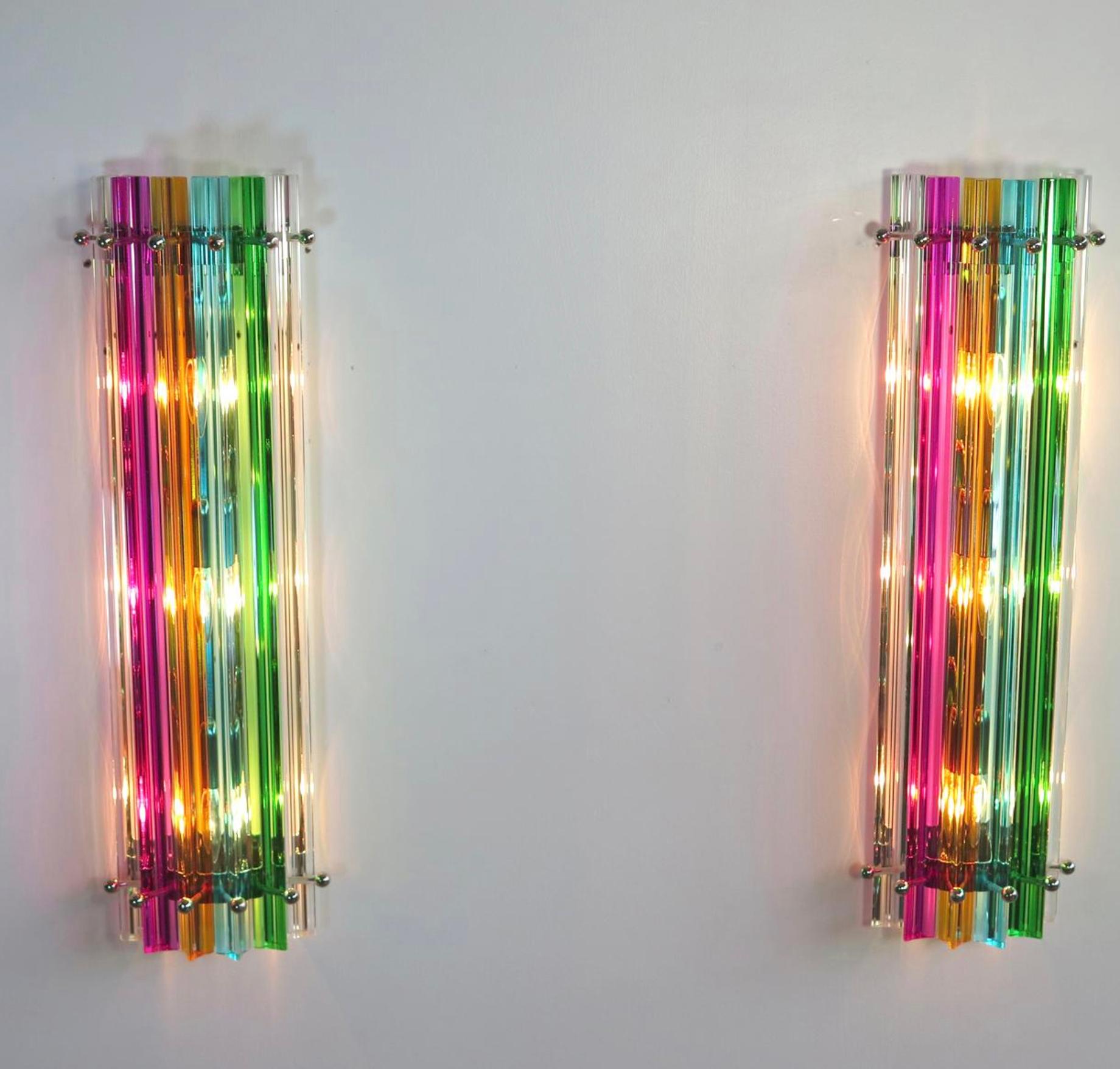 Pair vintage Murano wall sconces, multi-color triedri, Column Mariangela model.
Fantastic pair of vintage Murano wall sconce made by 6 Murano crystal prism (triedri) for each applique in a chrome metal frame. The shape of this sconce is column. The