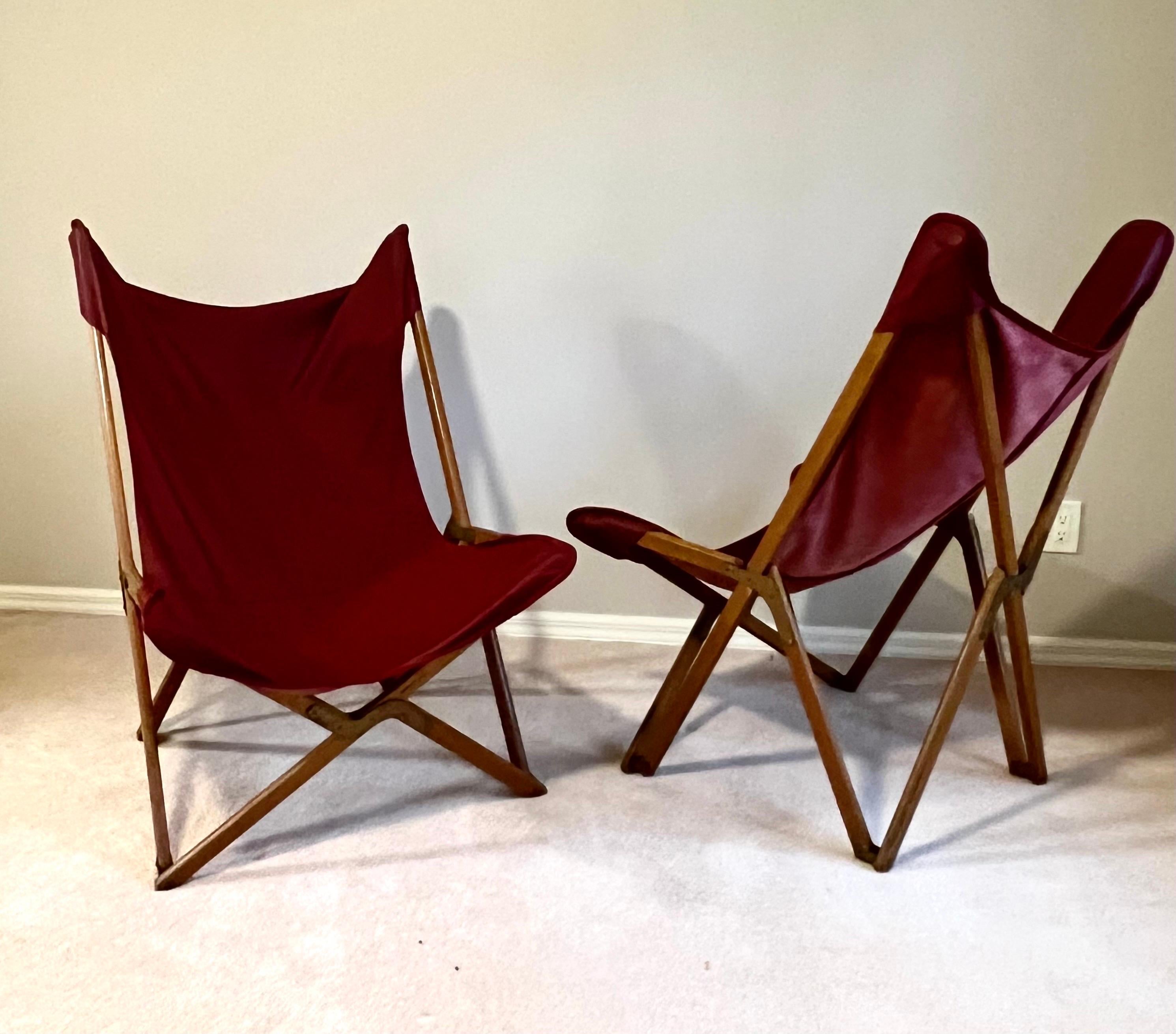 A rare and inportant pair of the 'Tripolina' folding chairs designed by Joseph B. Fenby. Tripolina folding chairs present a wooden frame with metal fixings and a beautiful removable seat realized in high-quality leather. These lounge chairs are