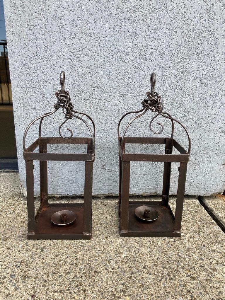 Pair of wrought iron lanterns with original chains. Nice patina, great form. Each with it's own hand wrought hook and removable chain. Said to have originally come from a Tuscan villa near Florence. 
We have 6 of these available. 
22 inches high
