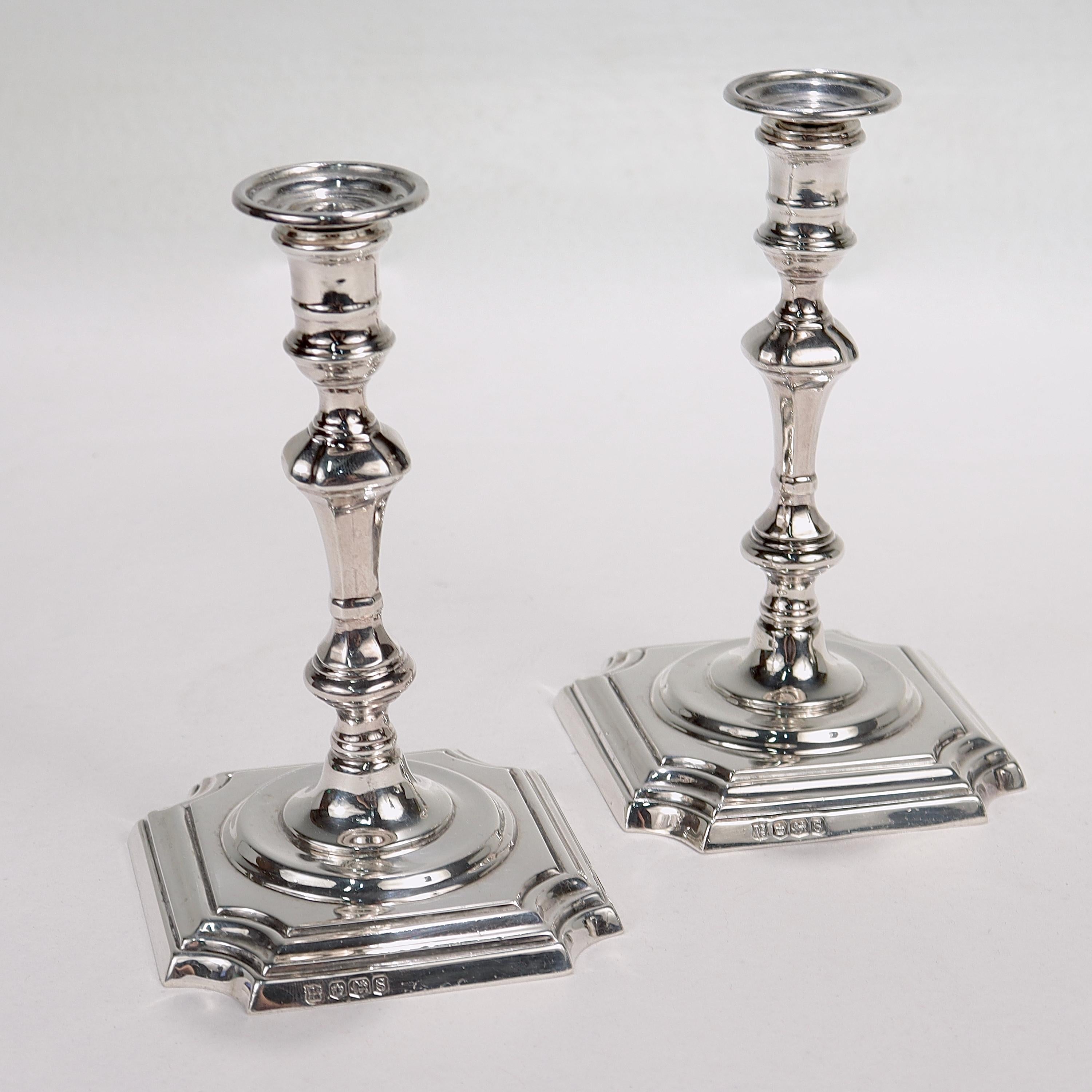 A fine pair of sterling silver taper candlesticks.

By Thomas Bradbury & Son for James Robinson.

Each candlestick with a square base with indented & rounded corners supporting a tapered body imitating classic 18th Century style.

Each marked to the