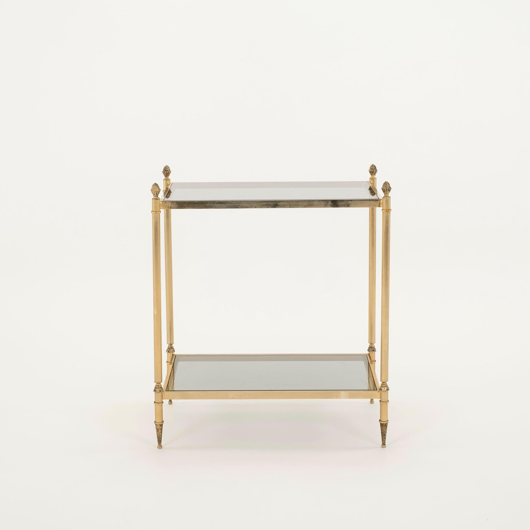 Pair of reeded and cast brass two tiered occasional tables with smoked glass.