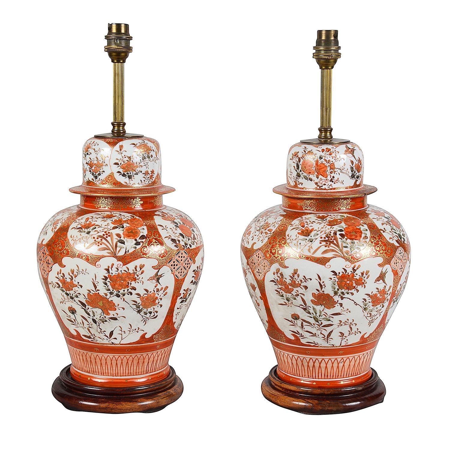 A good quality pair of late 19th Century Japanese Kutani porcelain vases / lamps. Each with the classical bold orange ground with scrolling gilded decoration. Inset hand painted panels depicting exotic floral scenes.

Batch 77