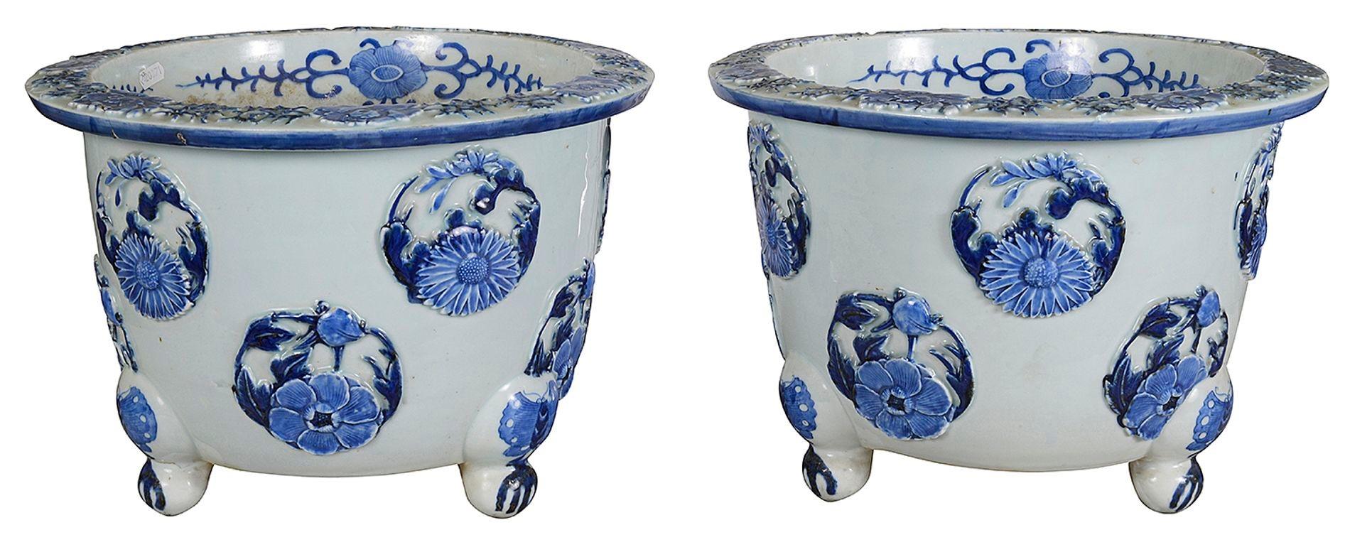 A very good quality pair of late 19th Century Japanese Blue and White Jardinieres, each with a white ground and raised circular relief panels depicting exotic flowers, raised on three scrolling feet with butterflies on. Circa 1880


Batch 83.