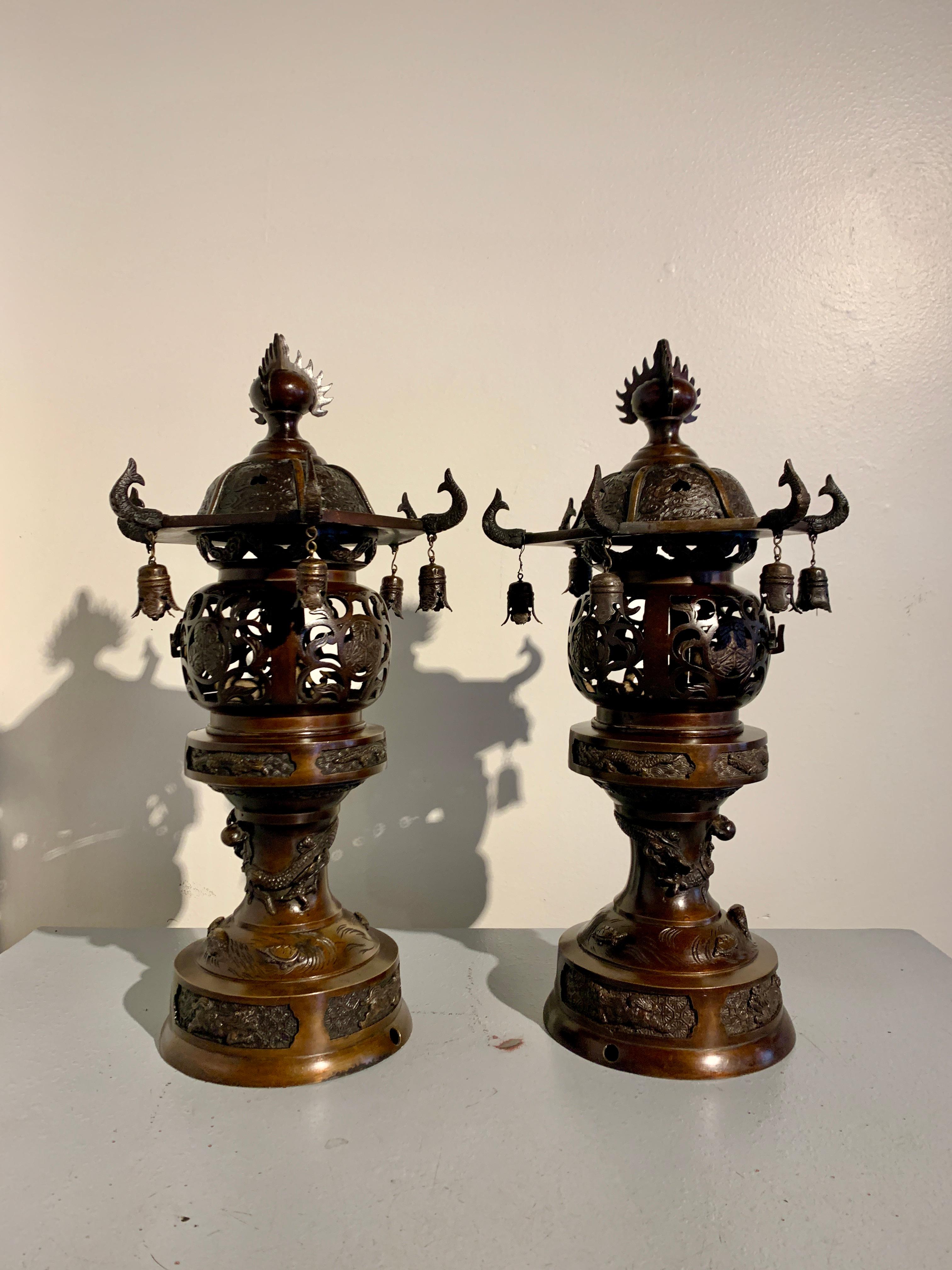 An elegant pair of Japanese cast and lacquered bronze pagoda lanterns, Taisho Period, circa 1920, Japan.

The lanterns a true pair, with mirrored decorations and lantern doors opening in opposite directions. The lanterns of traditional toro form,