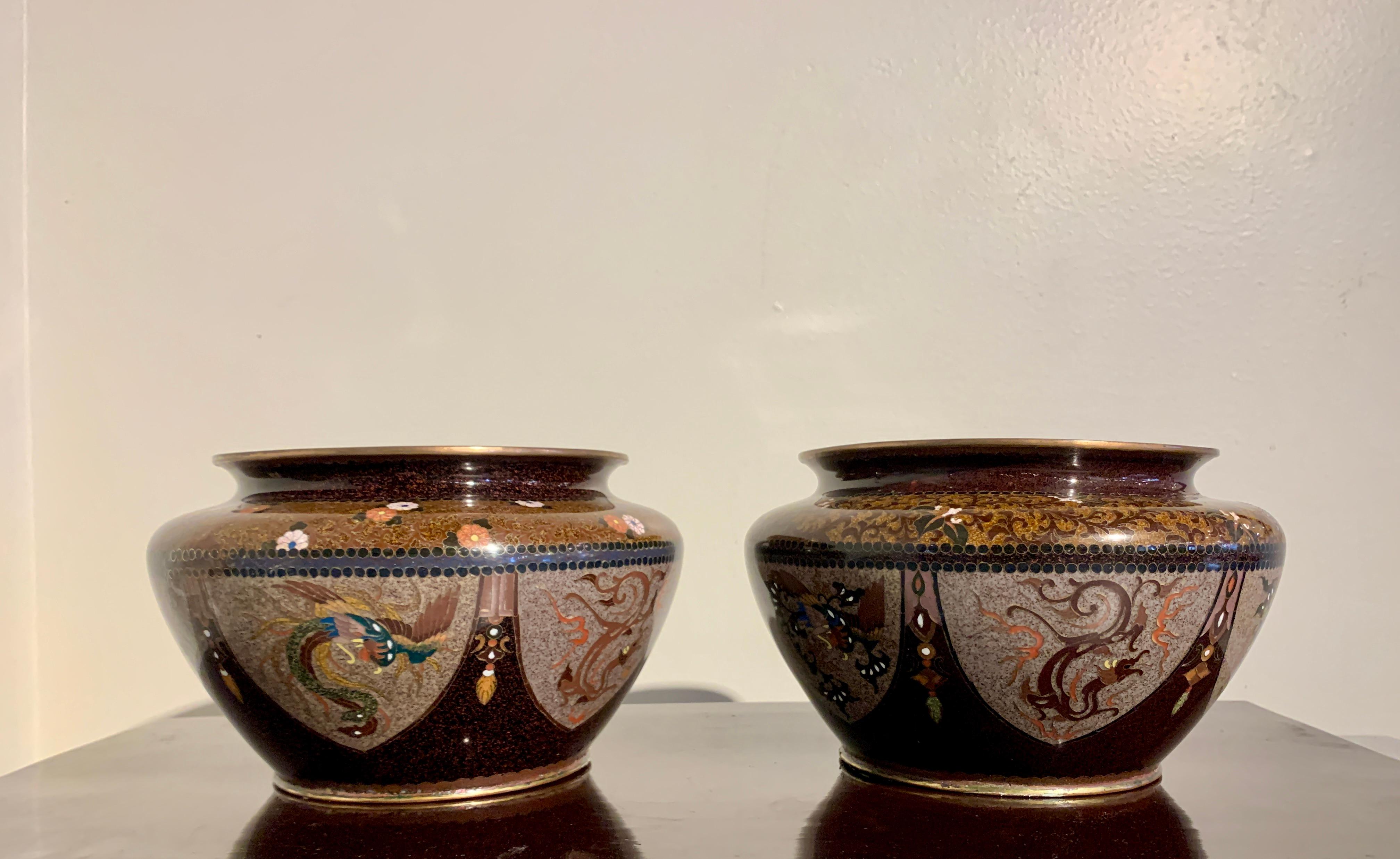 A lovely pair of Japanese chakinseki, tea dust, cloisonne jardinieres, Meiji Period, circa 1900, Japan. 

The jardinieres each with a squat globular body, short neck, and wide, everted mouth. The bodies decorated wide lappets of mottled puce