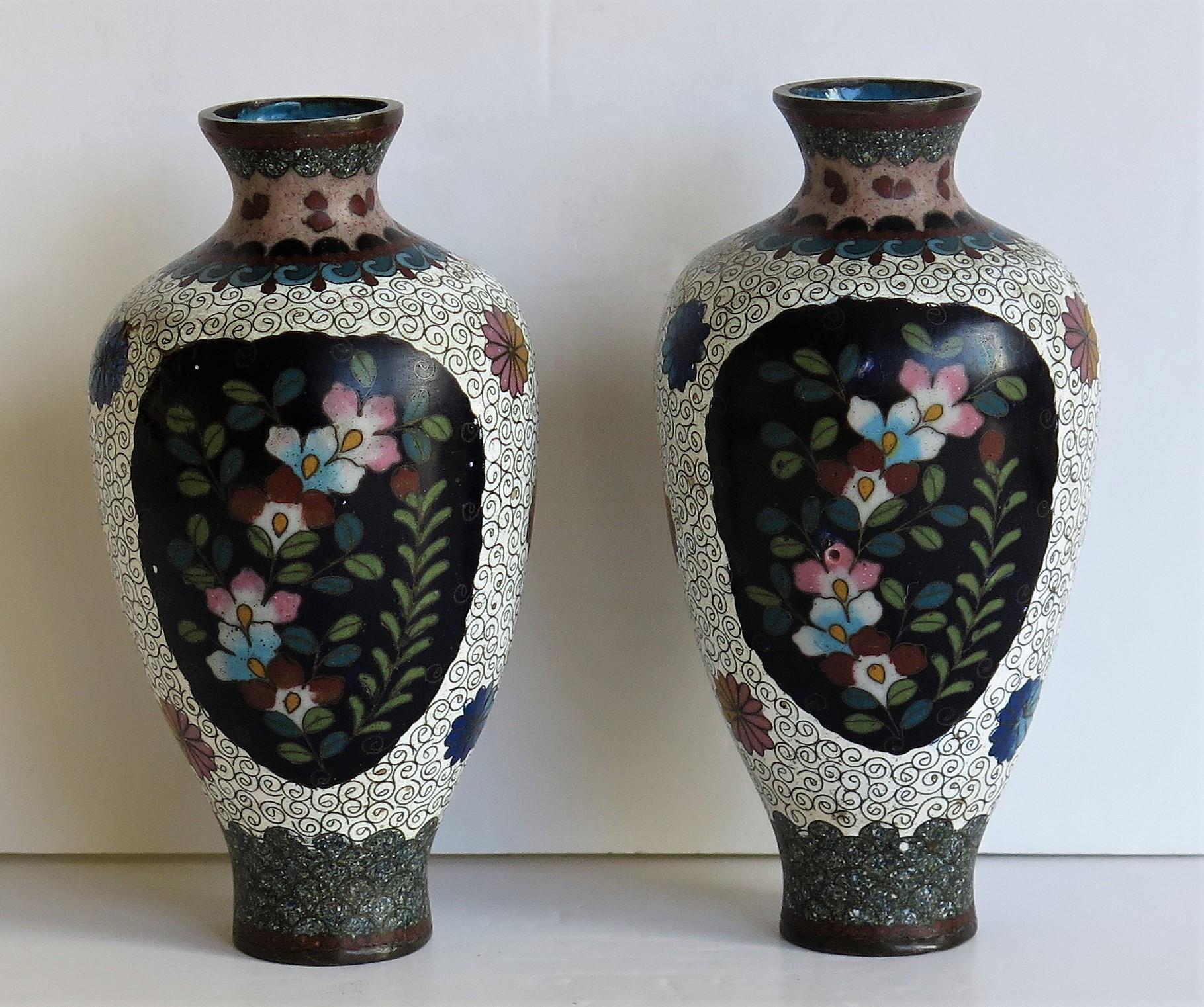 These are a very decorative pair of cloisonné vases, made in Japan and dating to the 19th Meiji Period, circa 1875.

The vases have a good baluster shape with a circular form. They have been well made of a bronze alloy with rich enamels of many