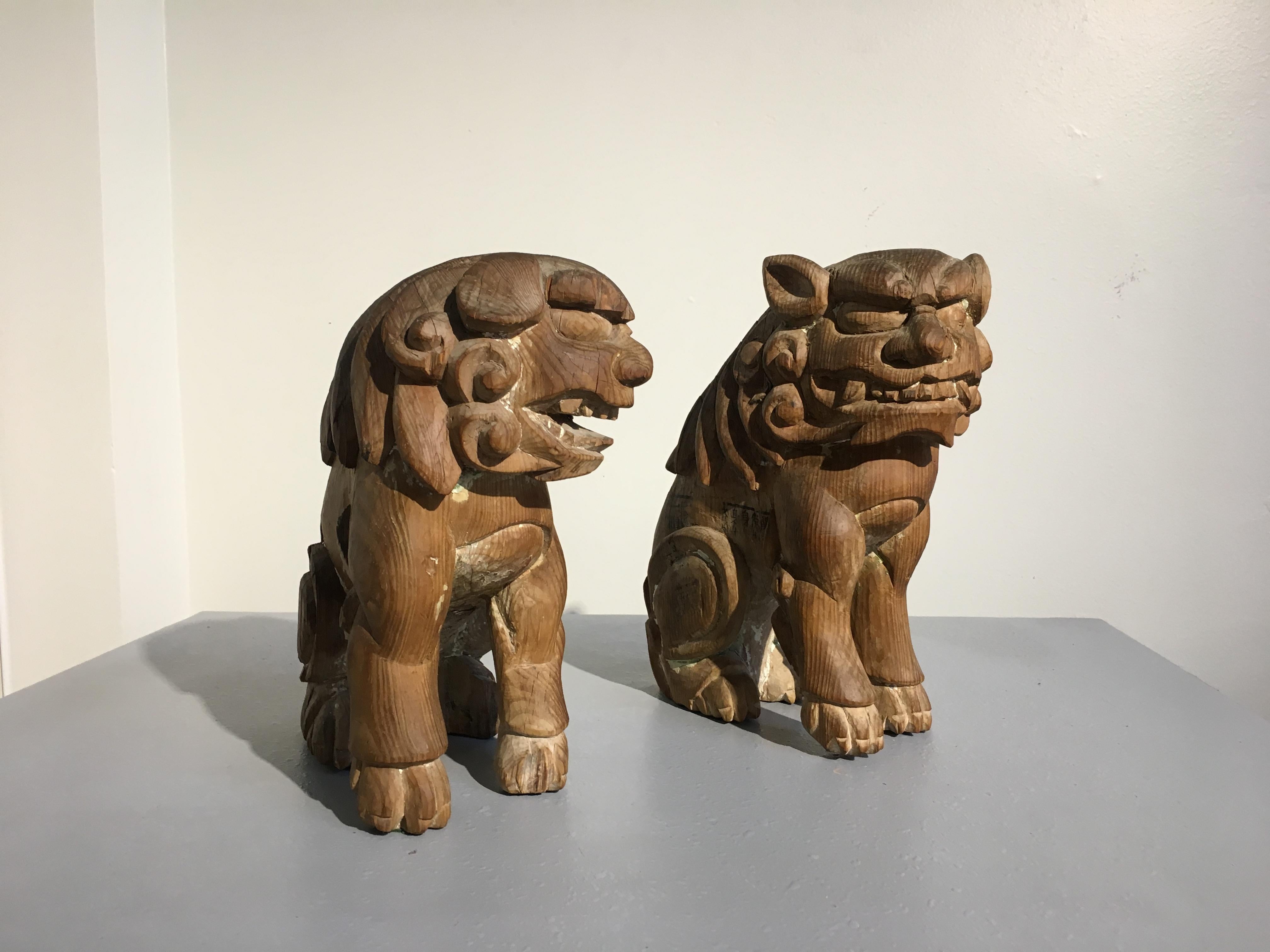 a pair of wooden koma-inu guardian dogs