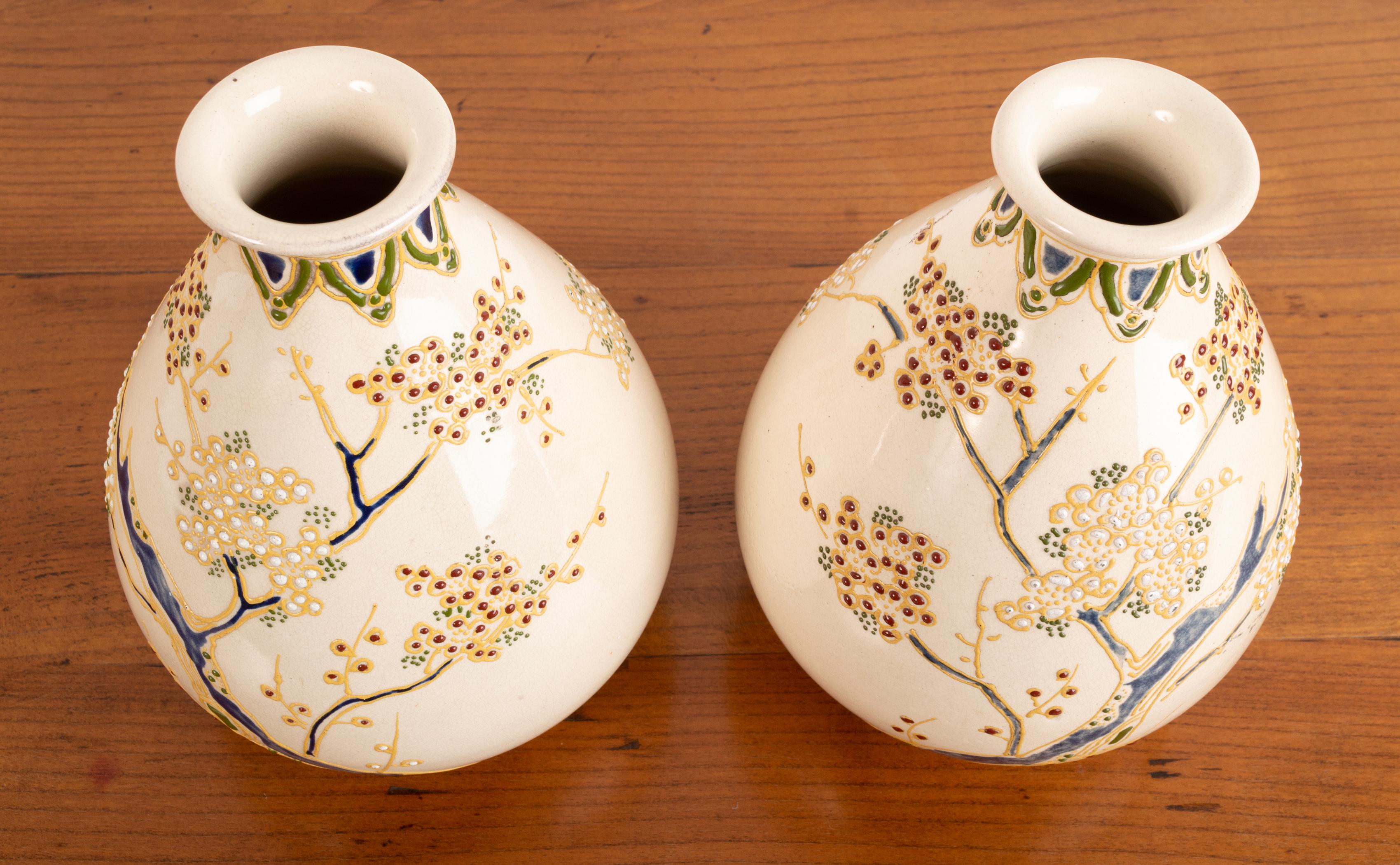 A pair Japanese export vases 
Japan C.1900 
Stamped 'Nippon'

A beautiful pair of delicately designed earthenware vases of Western taste depicting a hand-painted botanical pattern.

In excellent condition commensurate of age. Free from chips