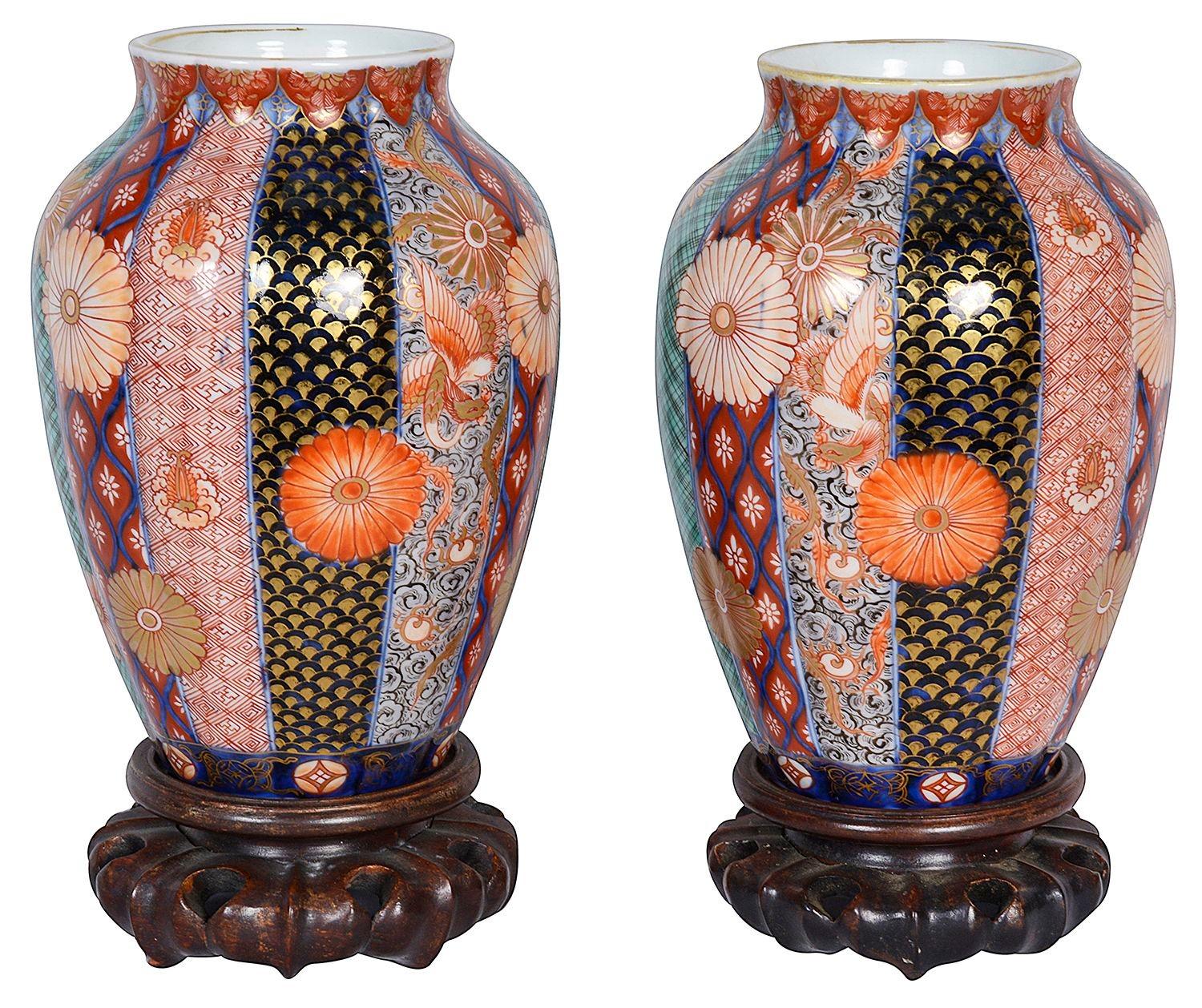 A fine quality pair of Meiji period (1868-1912) Japanese Fukagawa porcelain Imari vases on carved hardwood stands. Each vase with wonderful vertical hand painted panels depicting Classical Japanese motif decoration, exotic birds and flowers.
Signed