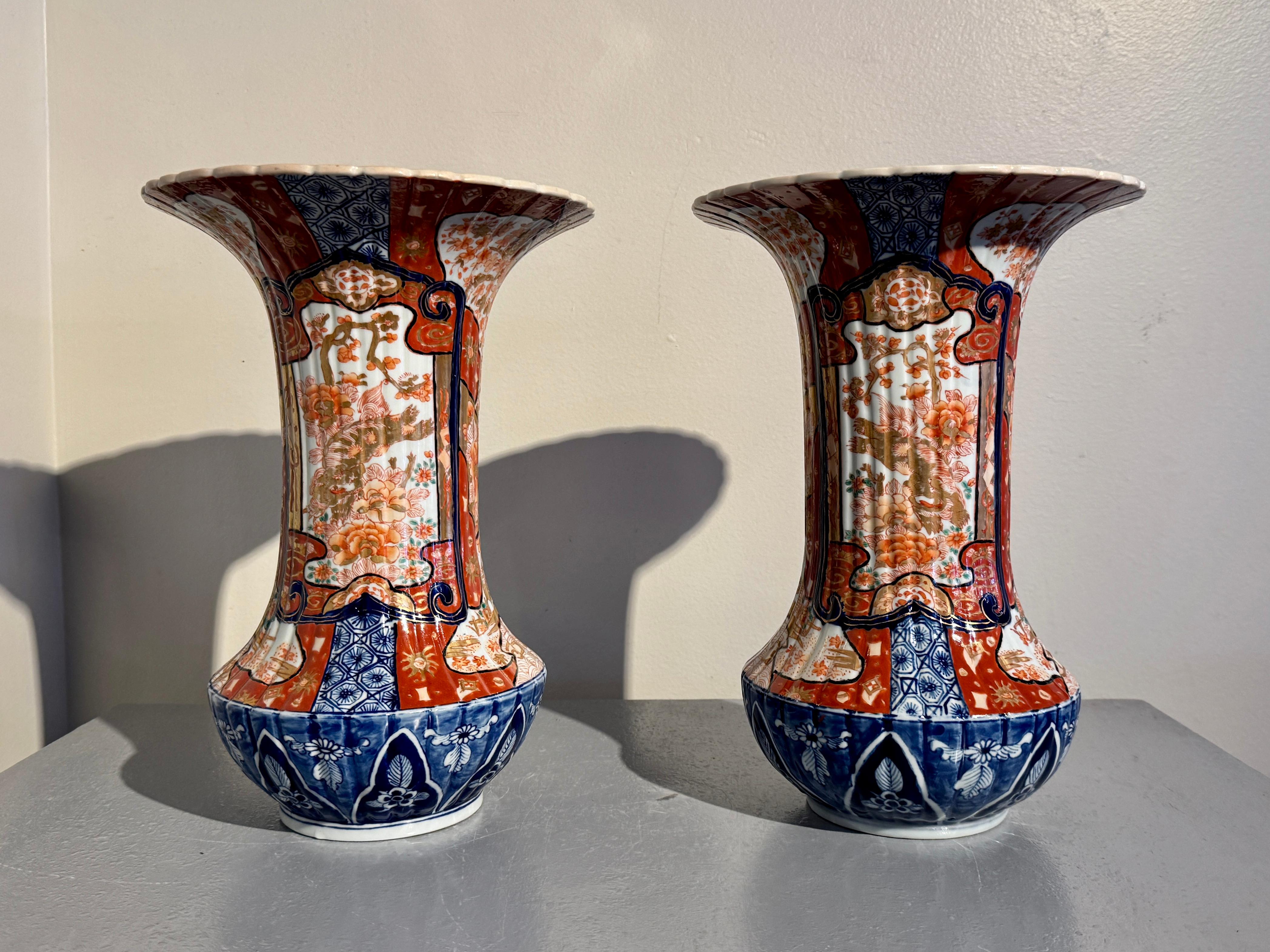 An unusual and dramatic matched pair of Japanese Imari fluted trumpet mouth vases, Meiji period, circa 1900, Japan.

The elegant vases feature a short and squat globular body with high shoulders and a wide and tall neck with a large flared trumpet