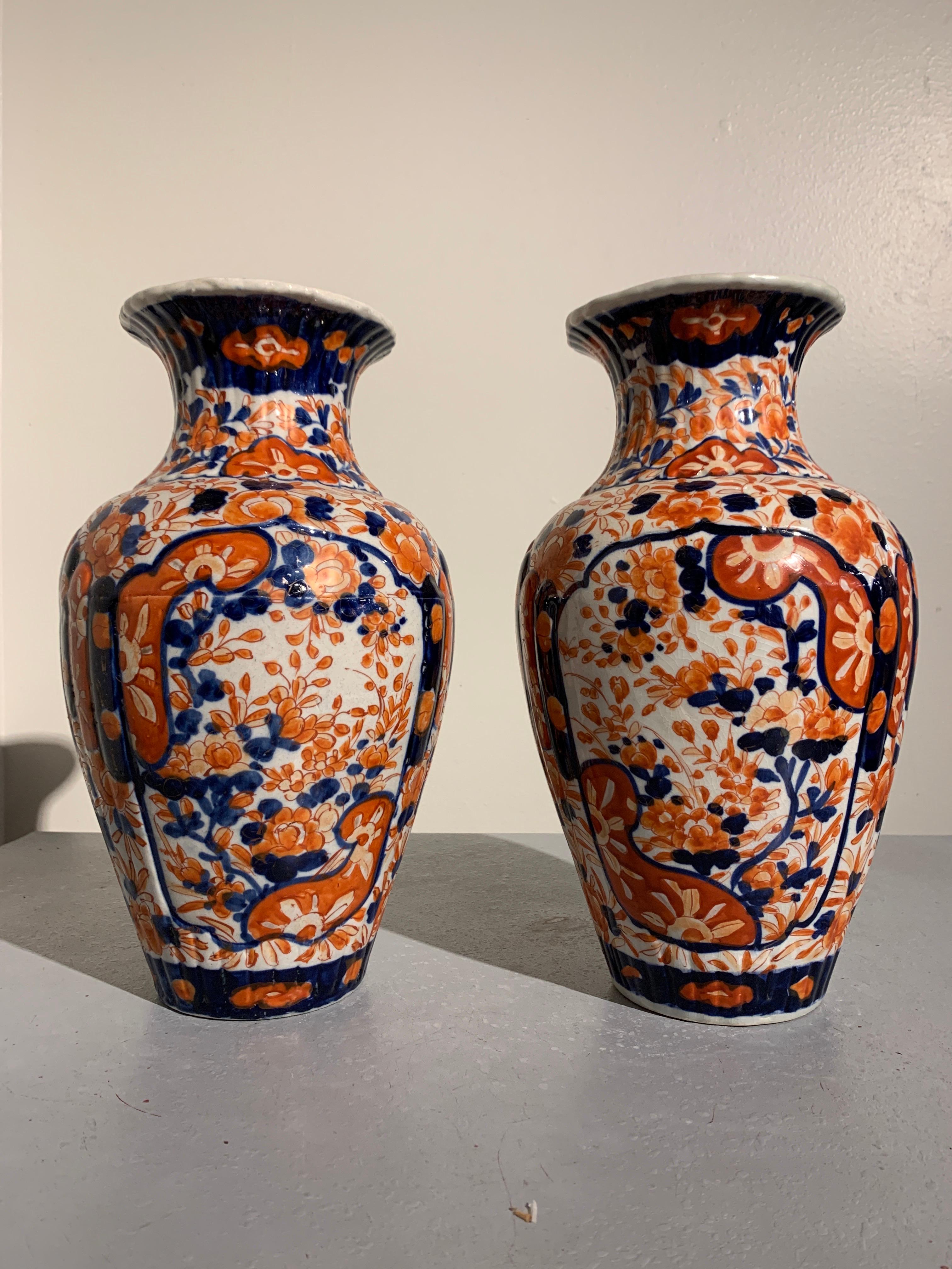 A lovely pair of Japanese Meiji period Imari vases, circa 1900.

The vases with fluted bodies of baluster form rising to a flaring mouth. The vases decorated with a dense flora design in the typical imari color palette of cobalt blue and burnt
