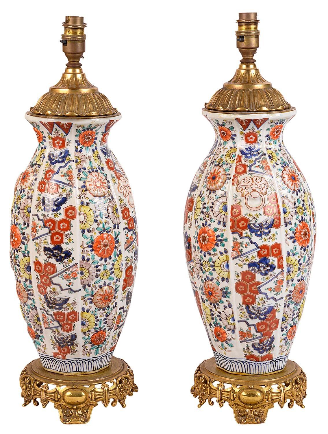 A very good quality pair of 19th century Japanese Imari facetted vases / lamps, each with classical floral and motif decoration, raised on wonderful French gilded ormolu oriental style stands.
 
Batch 72 G9523/2 YYKN.