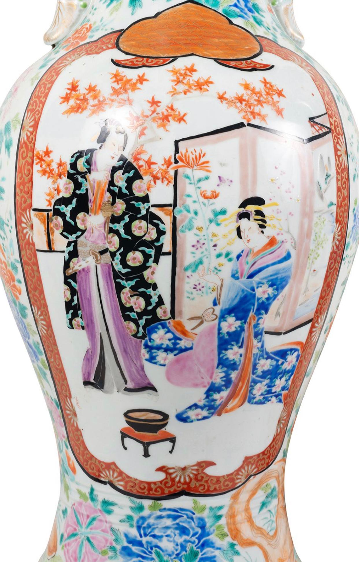 An impressive and very decorative pair of Meiji period (1868-1912) Japanese Kutani porcelain vases, each with wonderful exotic floral decoration to the ground, inset hand painted panels depicting a swords man looking over a Geisha girl cutting
