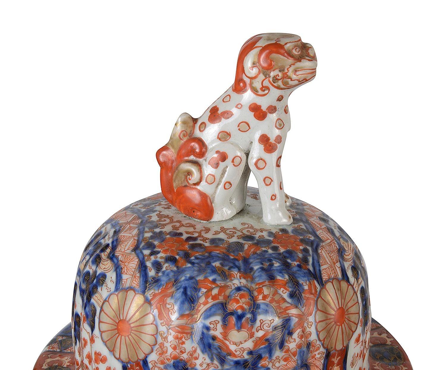 Pair of good quality late 19th Century Japanese lidded vases. each with a Foo Dog finial to the lid, wonderful bold blue and orange colours to the ground, classical motif and scrolling foliate decoration, inset hand painted panels depicting birds