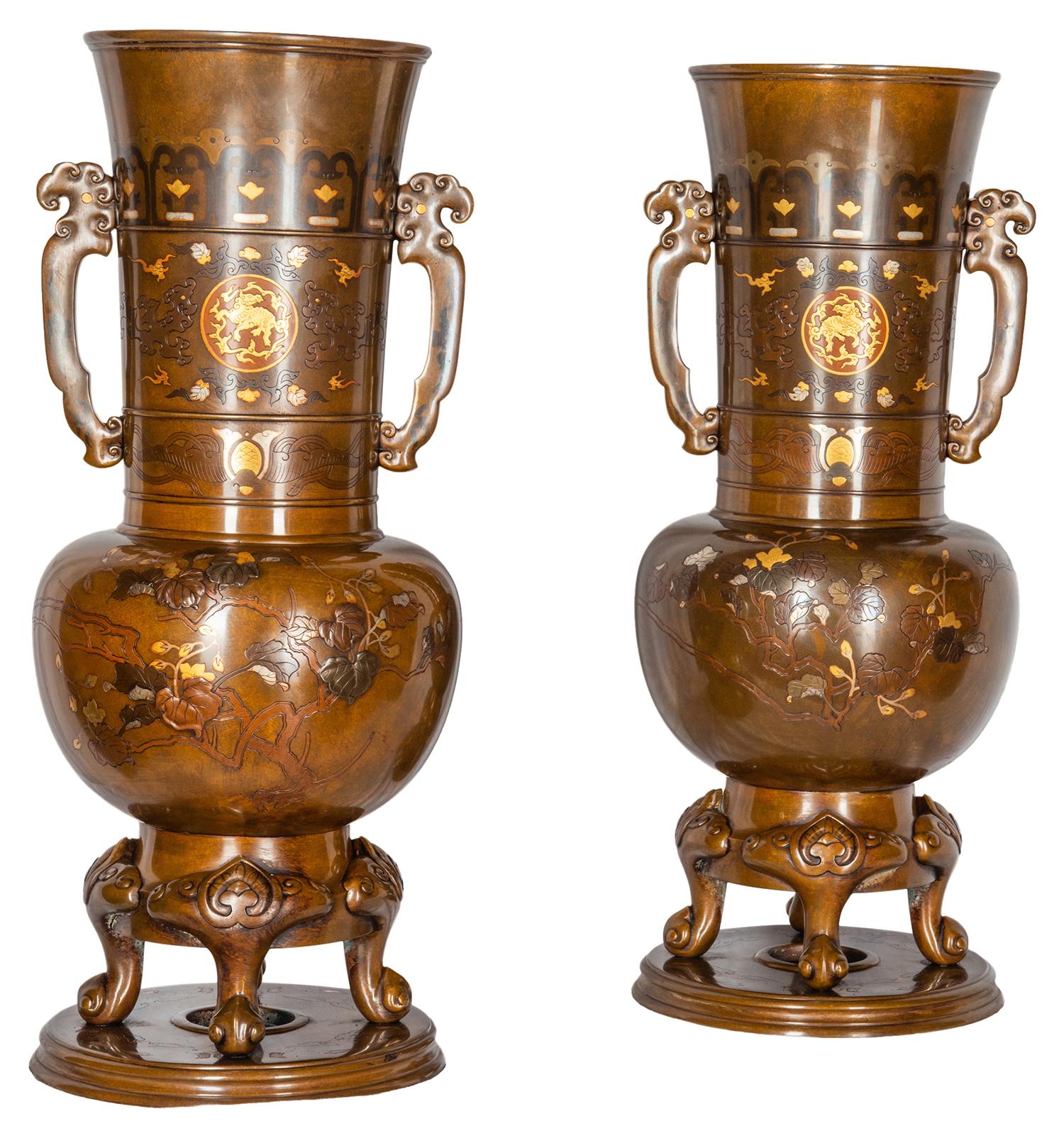 Pair of fine quality Japanese Meiji period (1868-1912) patinated bronze Miyao style gold and silver overlay two handled vases, each with twin handles, classical motif decoration with mythical creatures engraved and wonderful trees, leaves and buds.