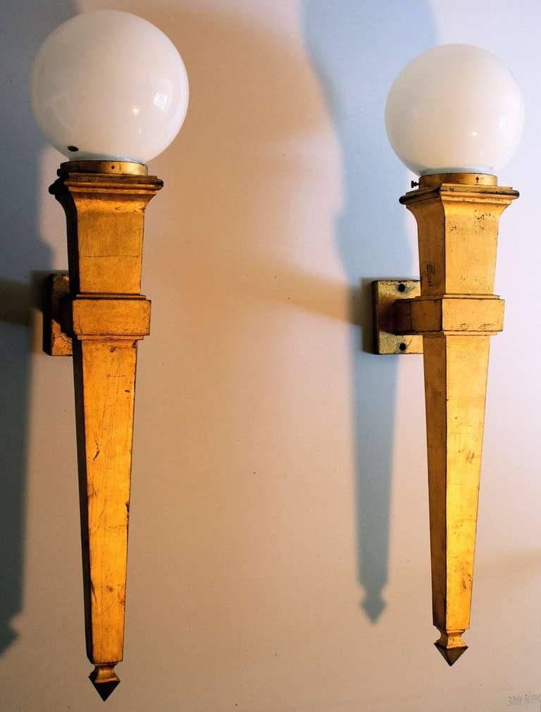 A pair of very large (27.5 inches high-exclusive of globes) Gilded Cast Iron (21 lbs. each) Wall Sconces. Not signed or otherwise marked.