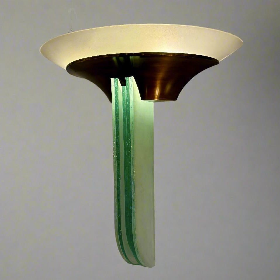 An important pair of French Art Deco large Jean Perzel sconces from France circa 1930. These unique sconces feature patinated brass, clear and frosted glass with textured edges. Signed: Jean Perzel