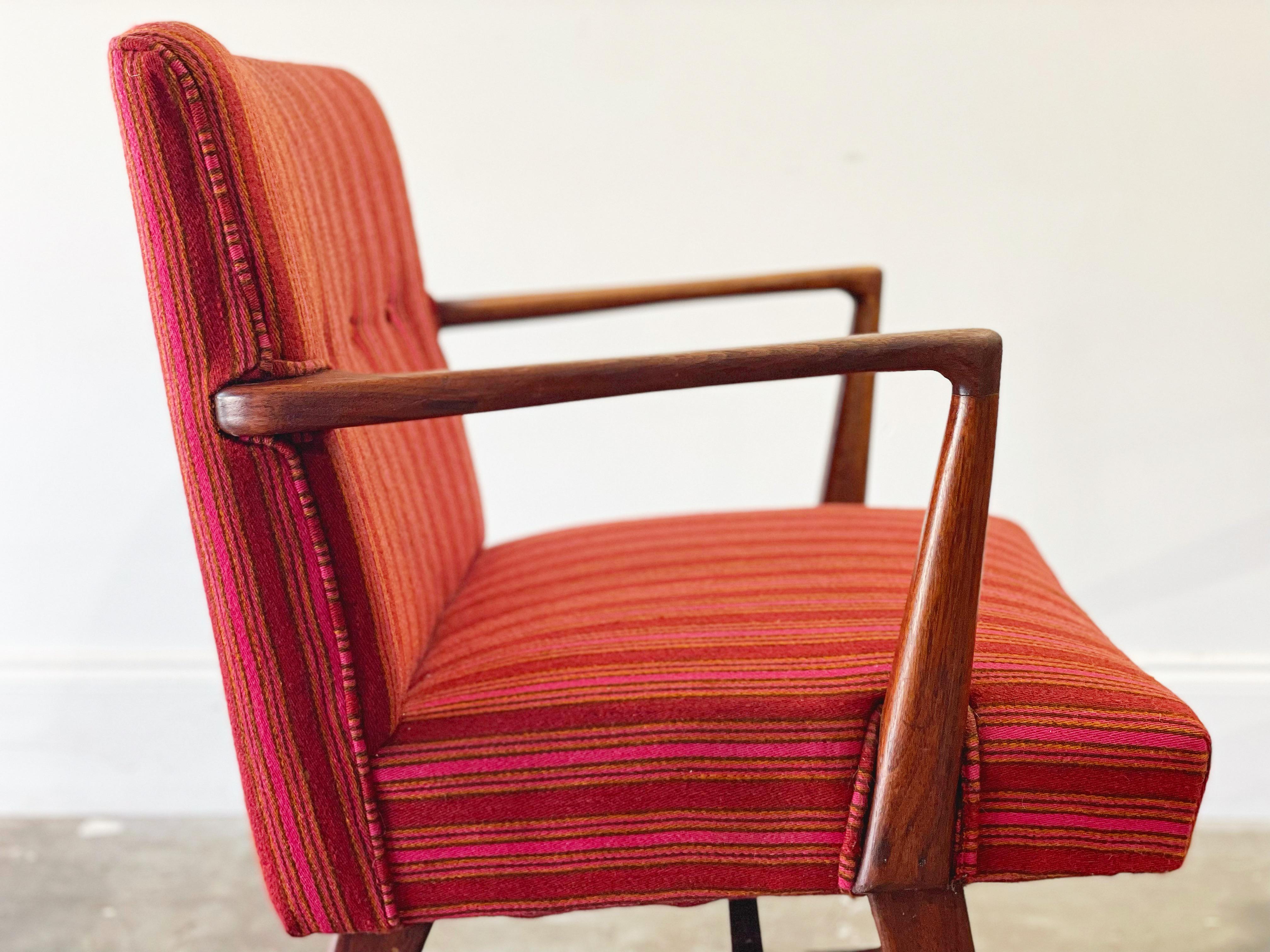 Fabulous pair of early Jens Risom model C108 armchairs in solid American black walnut with original Alexander Girard pink striped upholstery. Originally designed in 1948 shortly after Risom left Knoll. These examples have seen little use over the