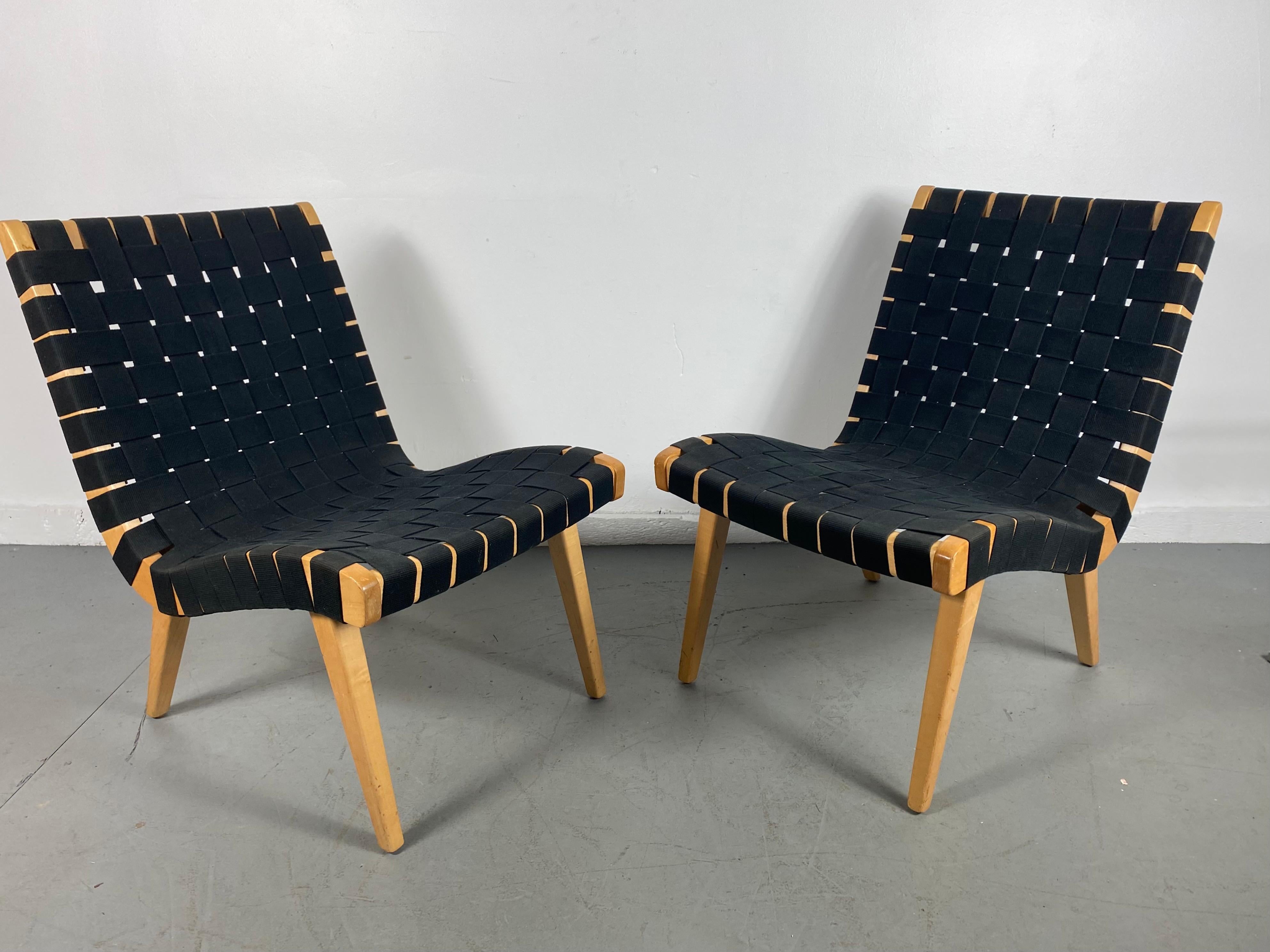 Pair of Jens Risom Webbed lounge chairs, Risom / Knoll, Classic Modernist, Jens Risom reintroduced webbed lounge chair. Originally designed in the late 1940s. These chairs are about 30 years old. Black webbing and birch wood frame. Classic Early
