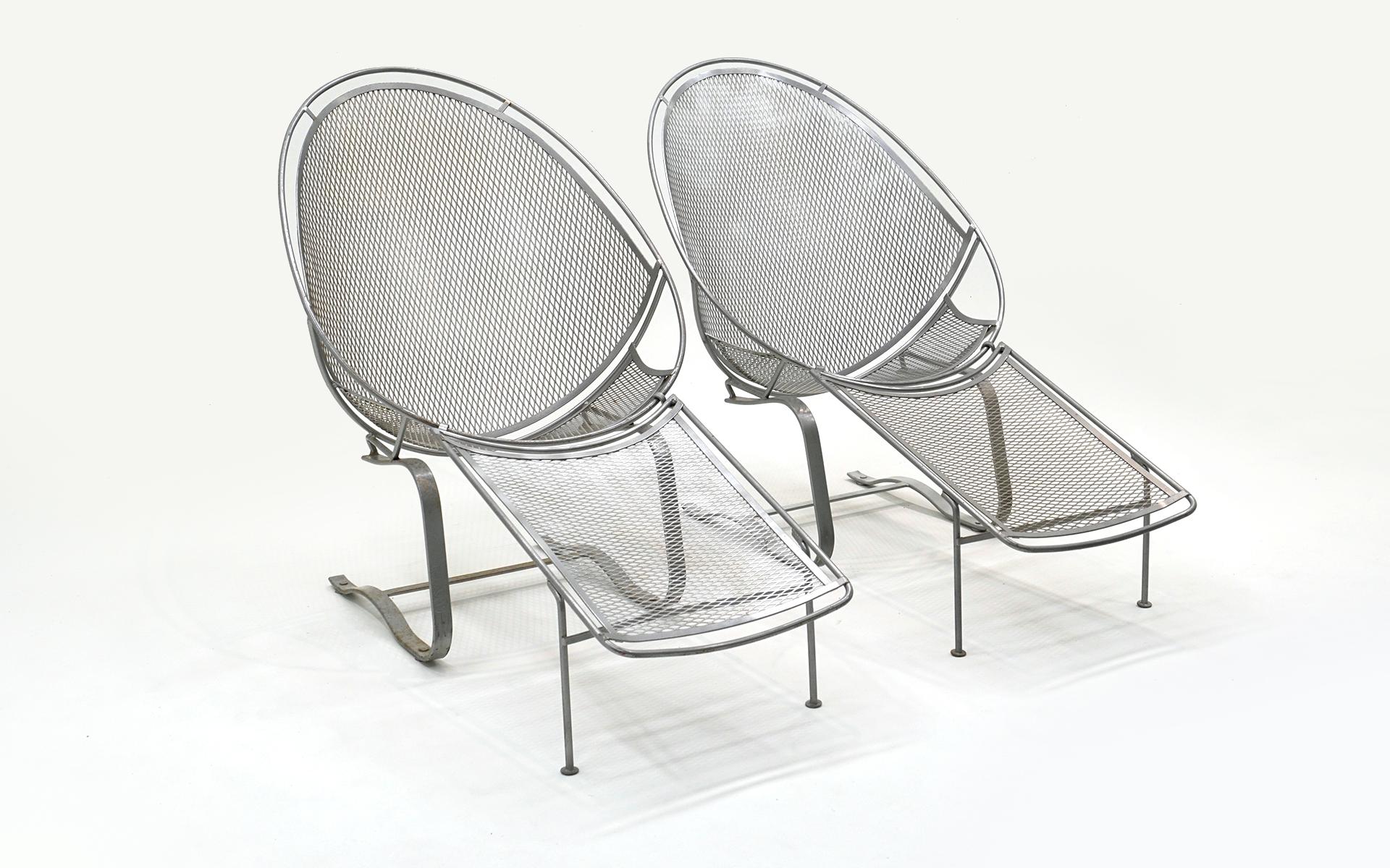 Pair of John Salterini patio, pool, oudoor lounge chairs on a springer base with footrests / ottomans that are removable.  These chairs are extremely comfortable.  They were powder coated in a silver finish and have spent three years outside so