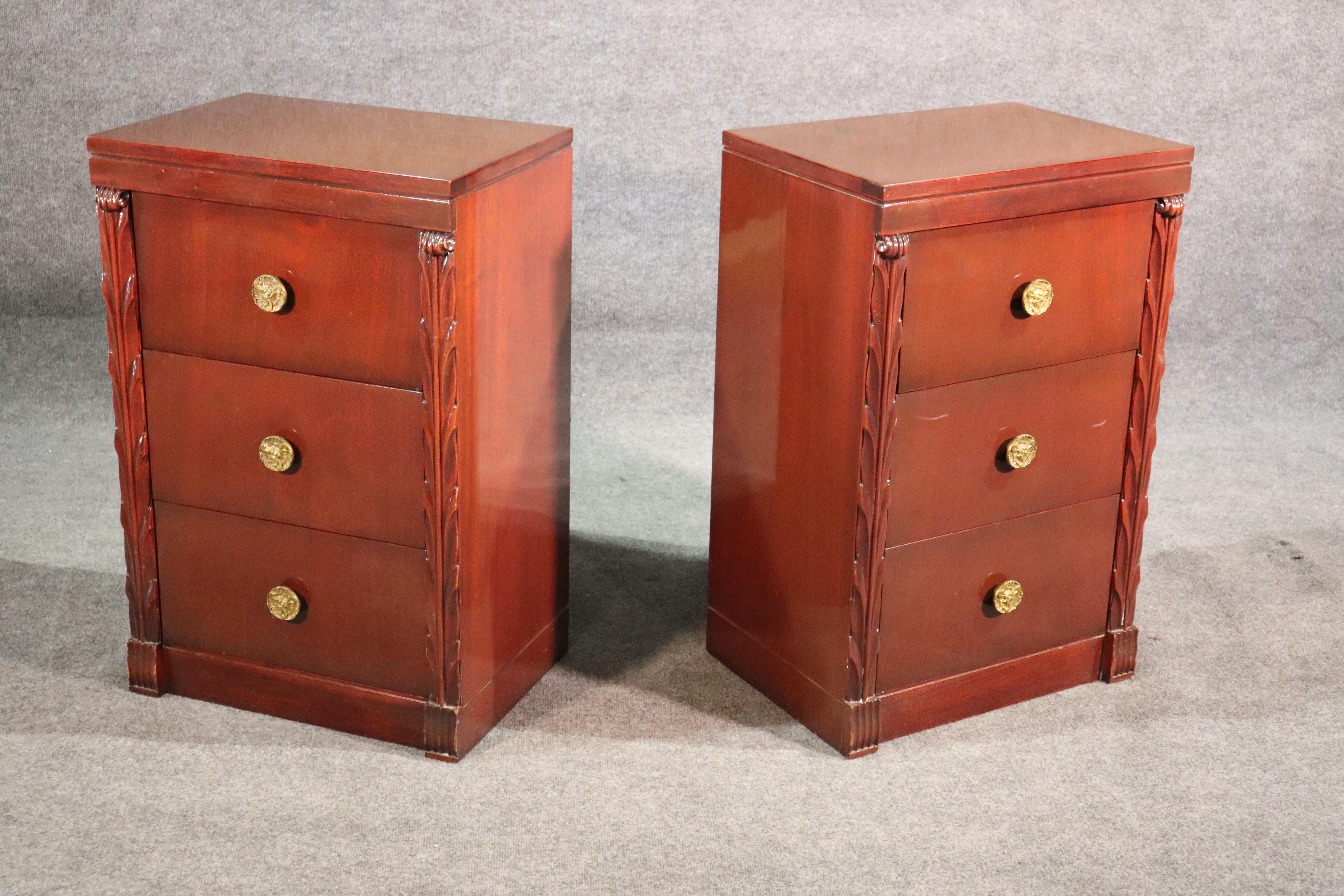 This is a nice pair of John Stuart nightstands in a red mahogany instead of a traditional brown mahogany, circa 1950. 

The stands measure 32.5 tall x 21 wide x 15 deep.