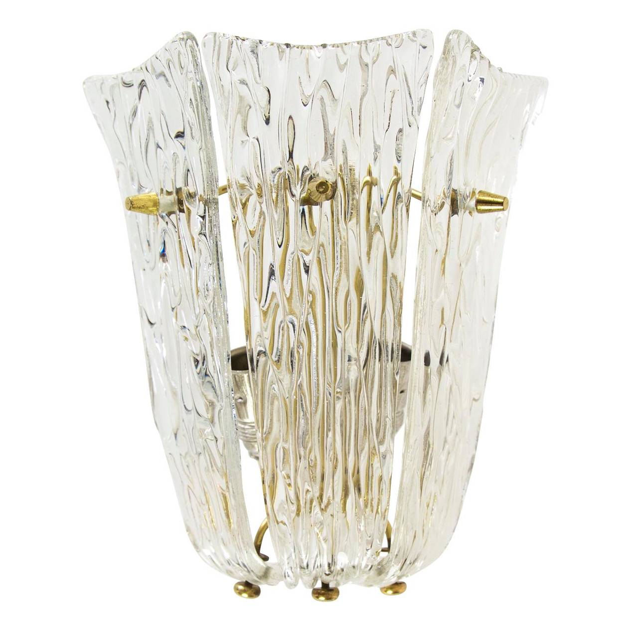 A pair of nice textured glass and brass wall lamps by J. T. Kalmar, Austria, Vienna, manufactured in midcentury, circa 1960 (late 1950s or early 1960s).
A sold brass backplate holds three curved textured and cast glass elements with brass bolts. The