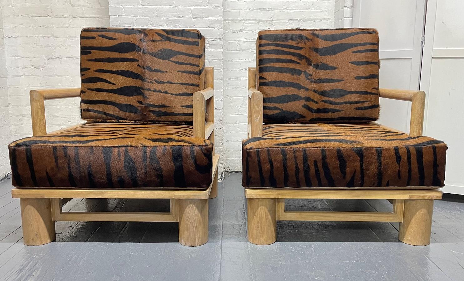 Pair of dowel Cerused wood lounge chairs in Zebra Hide. The chairs are well made, sturdy with zebra hide upholstery.
