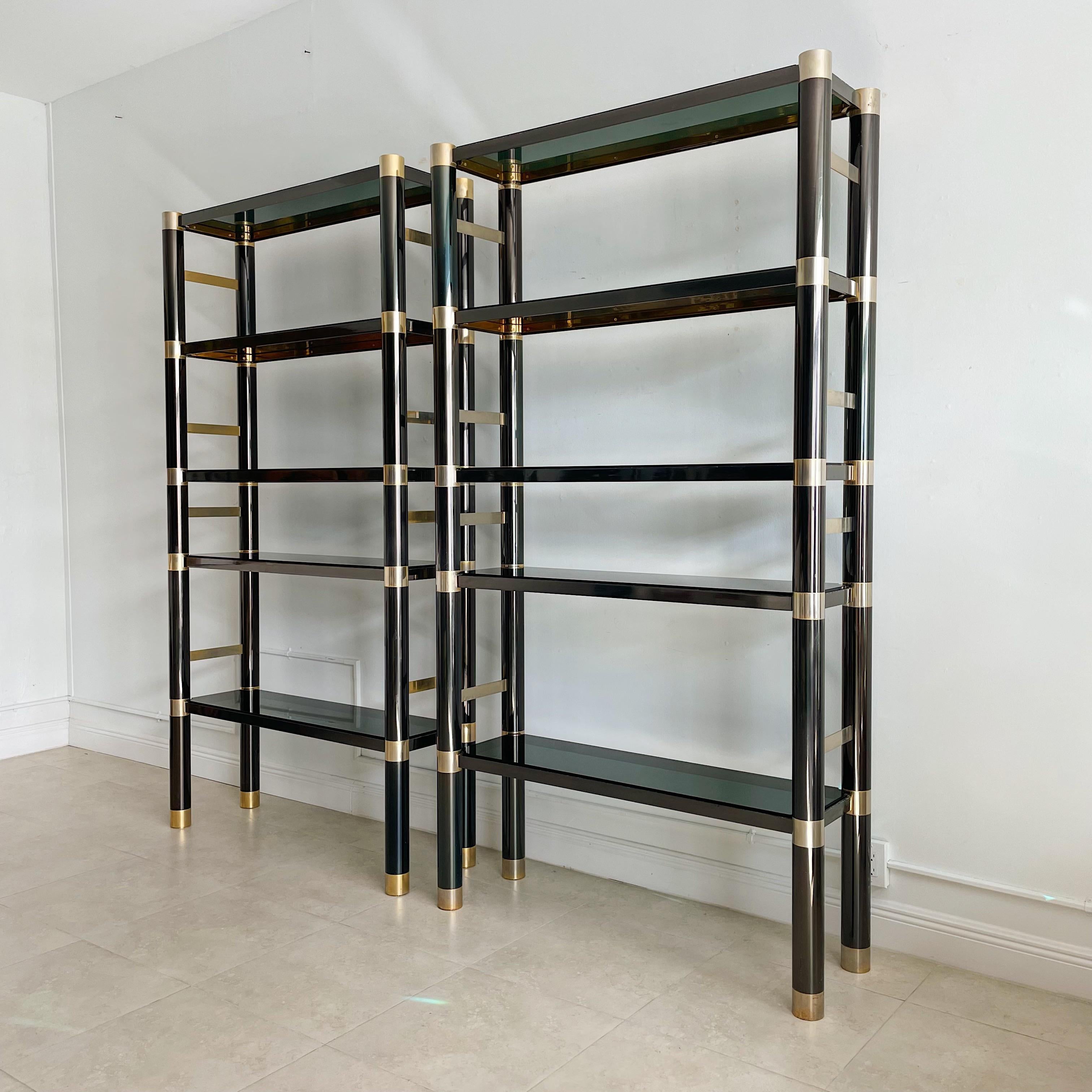 Pair of large gunmetal finish over solid brass rails etageres by Karl Springer. With original smoked glass shelving.