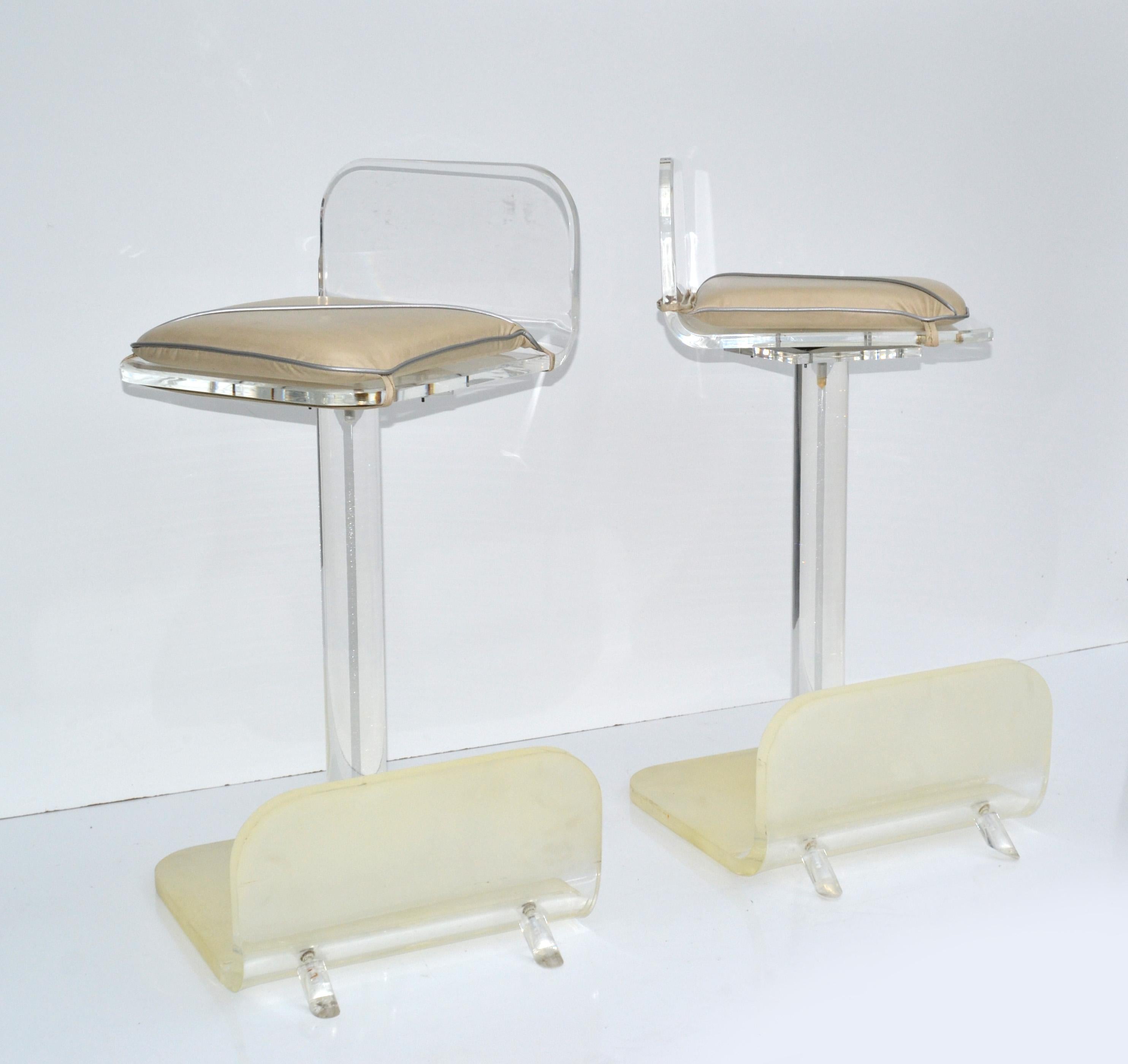 Pair of Karl Springer Mid-Century Modern frosted and clear Lucite Bar Stools made in America in the early 1980.
They have a smooth swivel and tilt Function and come with the original padded seat cushion.
In original vintage condition with some