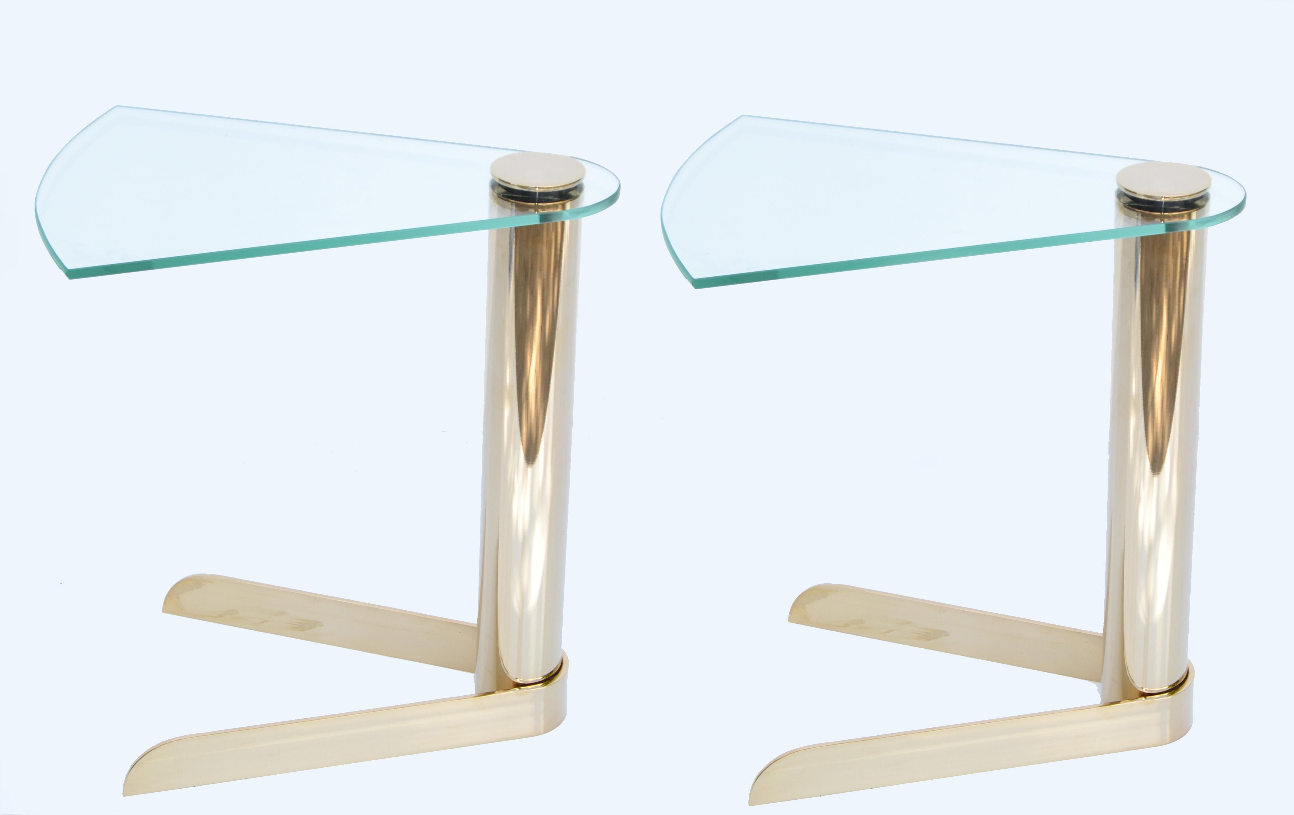 Pair of Drink, Side or Sofa tables in the style of Karl Springer made out of Brass, Gold Platted & Glass.
The iconic Glass Top swivels easily.
Mid-Century Modern made in America in the early 1980.