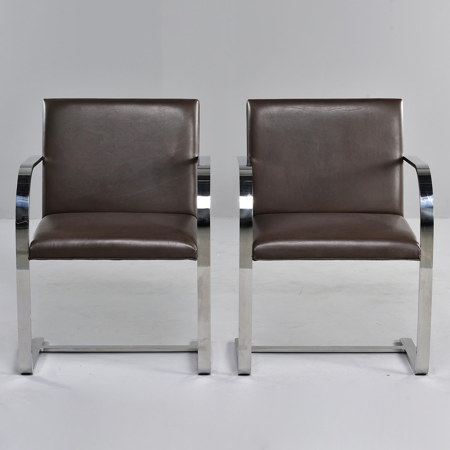 This pair of genuine Knoll Brno chairs is upholstered in dark brown leather. Designed by Mies van der Rohe in 1930 and still in current production by Knoll, these chairs with leather upholstery currently retail for $2630 each.
 