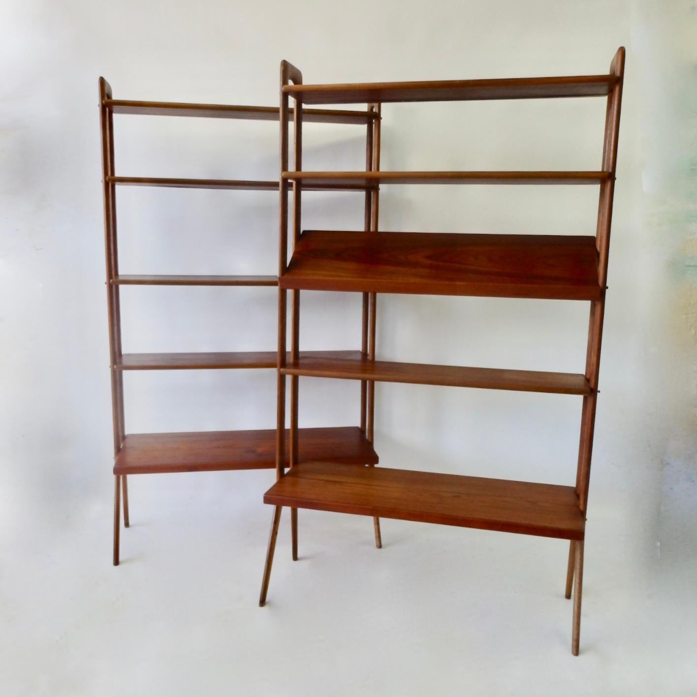 Pair of modular and adjustable Danish teak wood bookshelves or room divider. Designed by Kurt Ostervig crafted by Povl Dinesen. Five shelves on each unit. One having an angled magazine or book display shelf. Lower shelf is deeper at 15.75